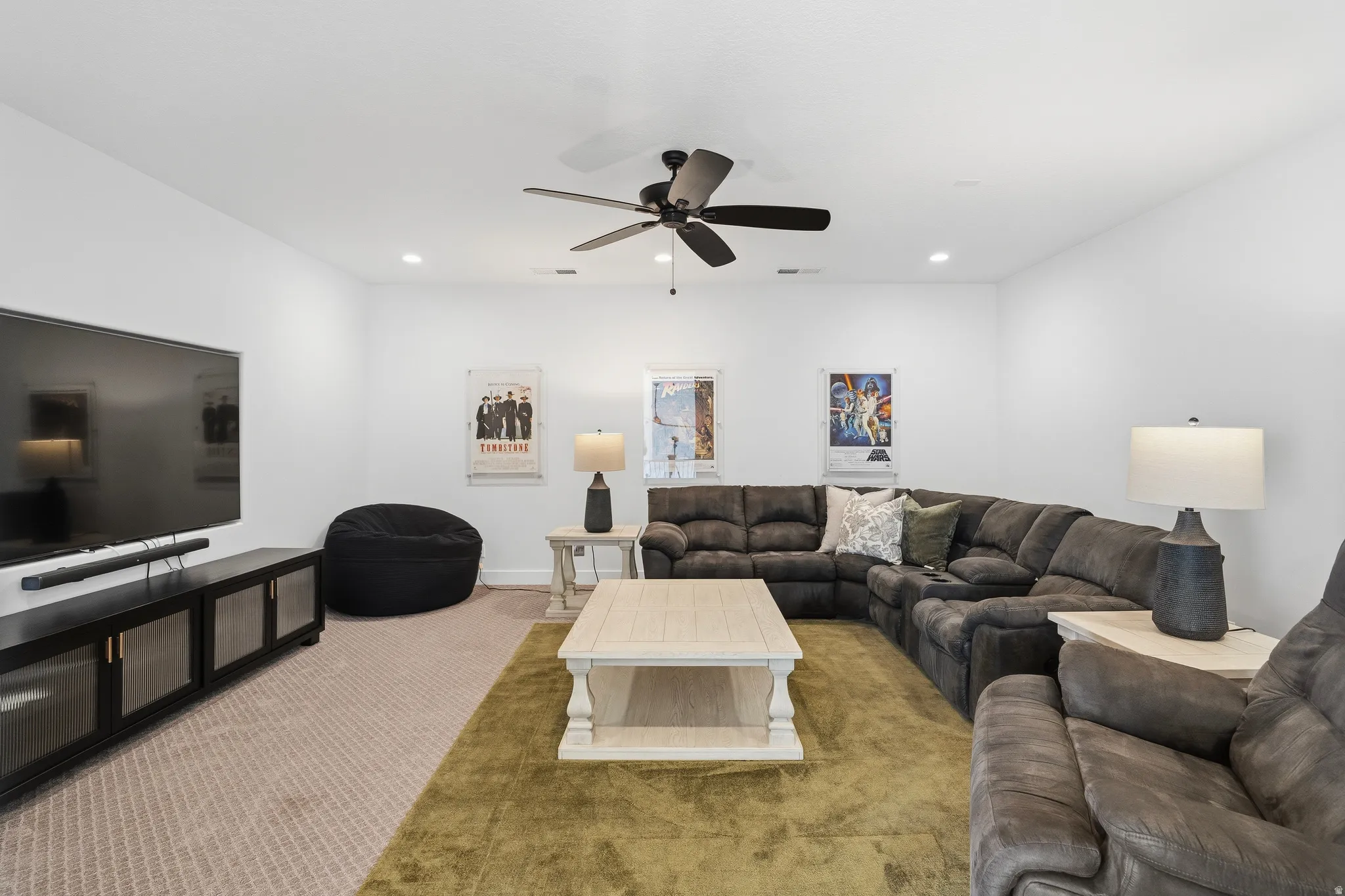 Spacious interior featuring a neutral color palette, recessed lighting, and a ceiling fan.