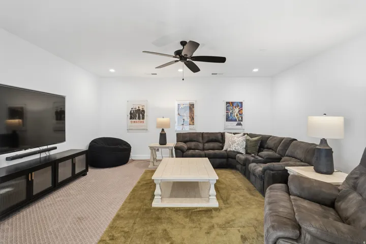 Spacious interior featuring a neutral color palette, recessed lighting, and a ceiling fan.