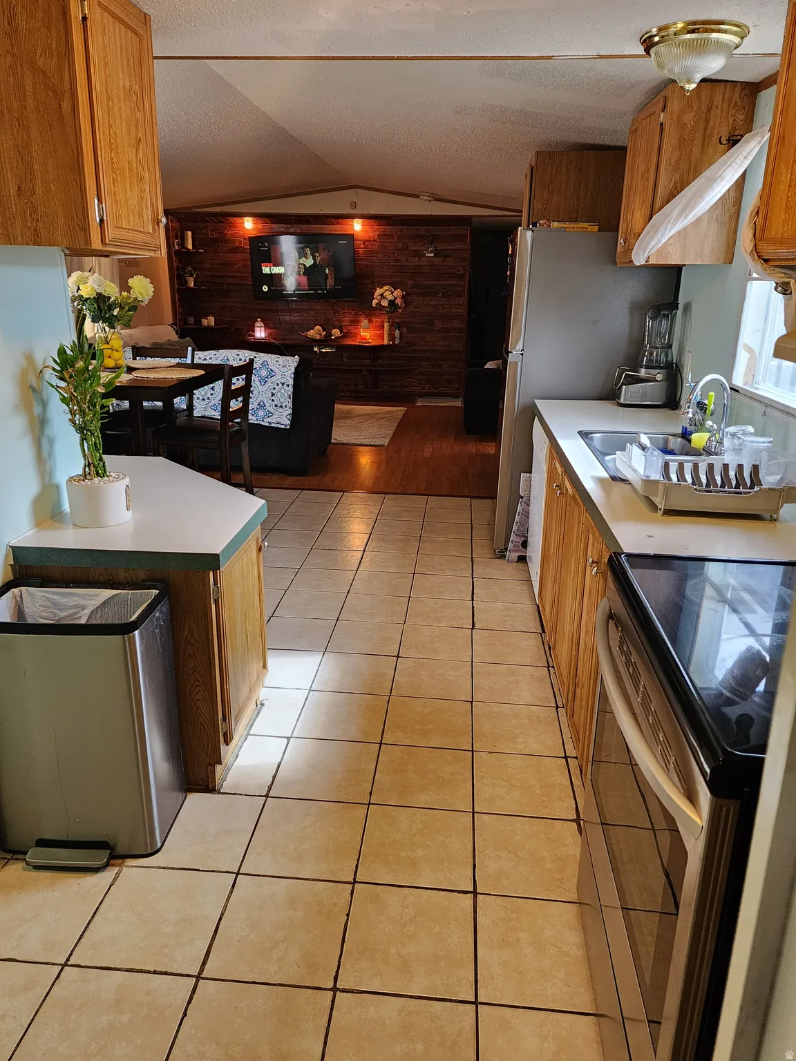 Kitchen featuring a stainless steel range, stainless steel refrigerator, and wood-finish cabinetry