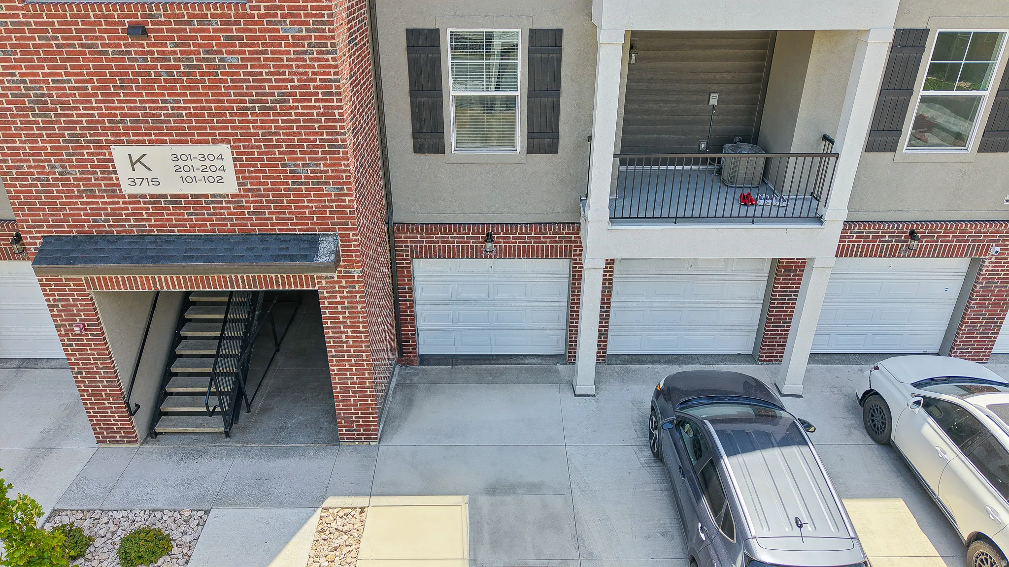 Brick and stucco exterior with multiple garage doors