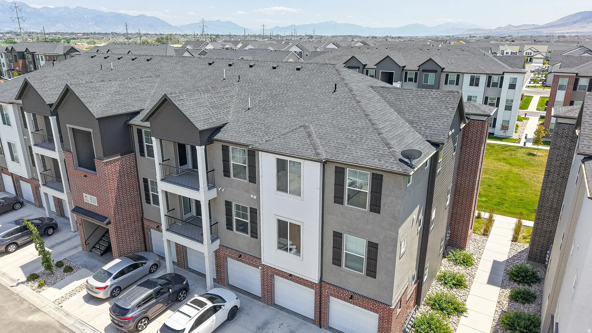 Contemporary townhome structure featuring a multi-tone facade with brick and stucco accents