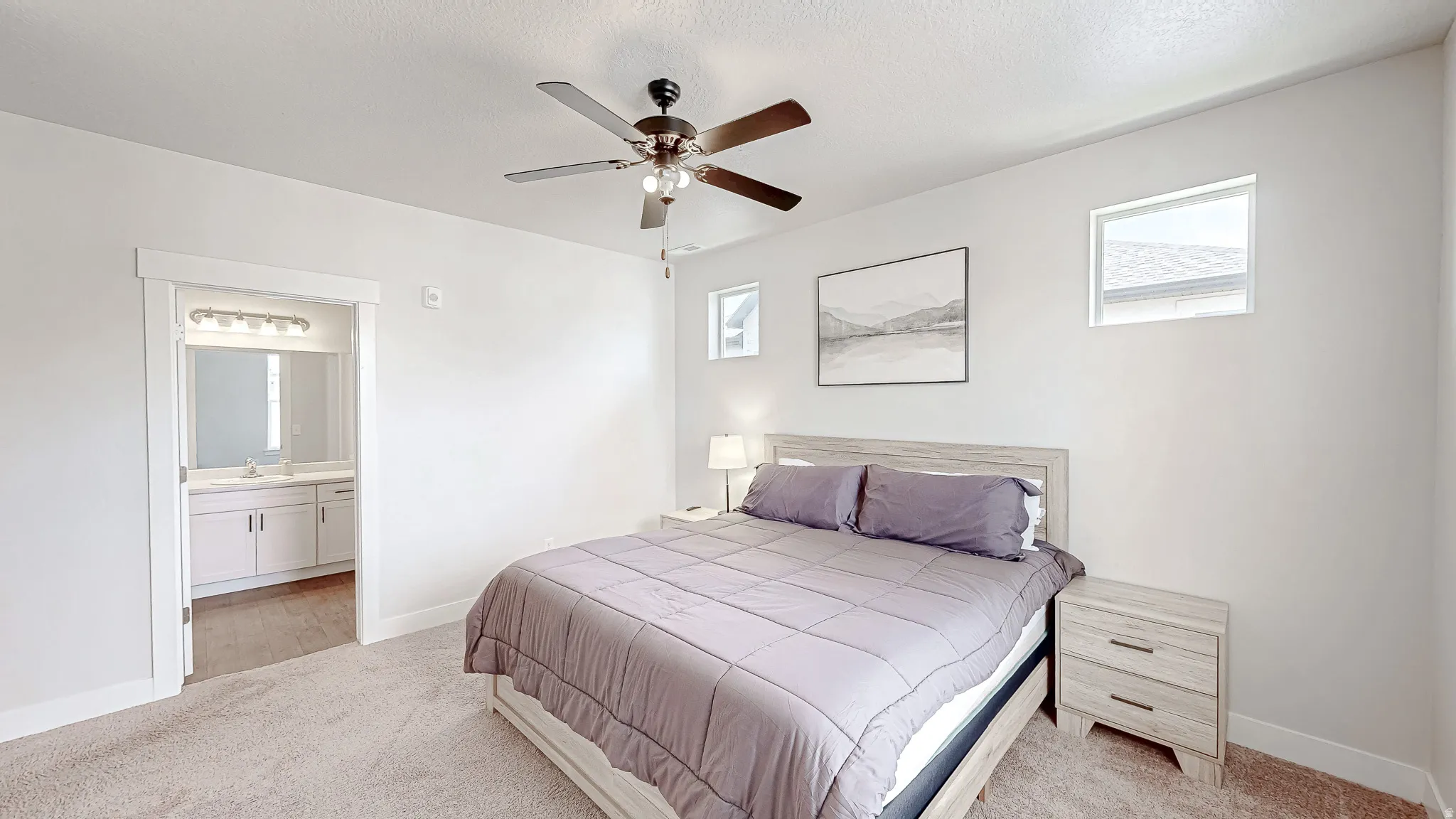 Bedroom featuring light-toned carpeting and a ceiling fan with integrated lighting
