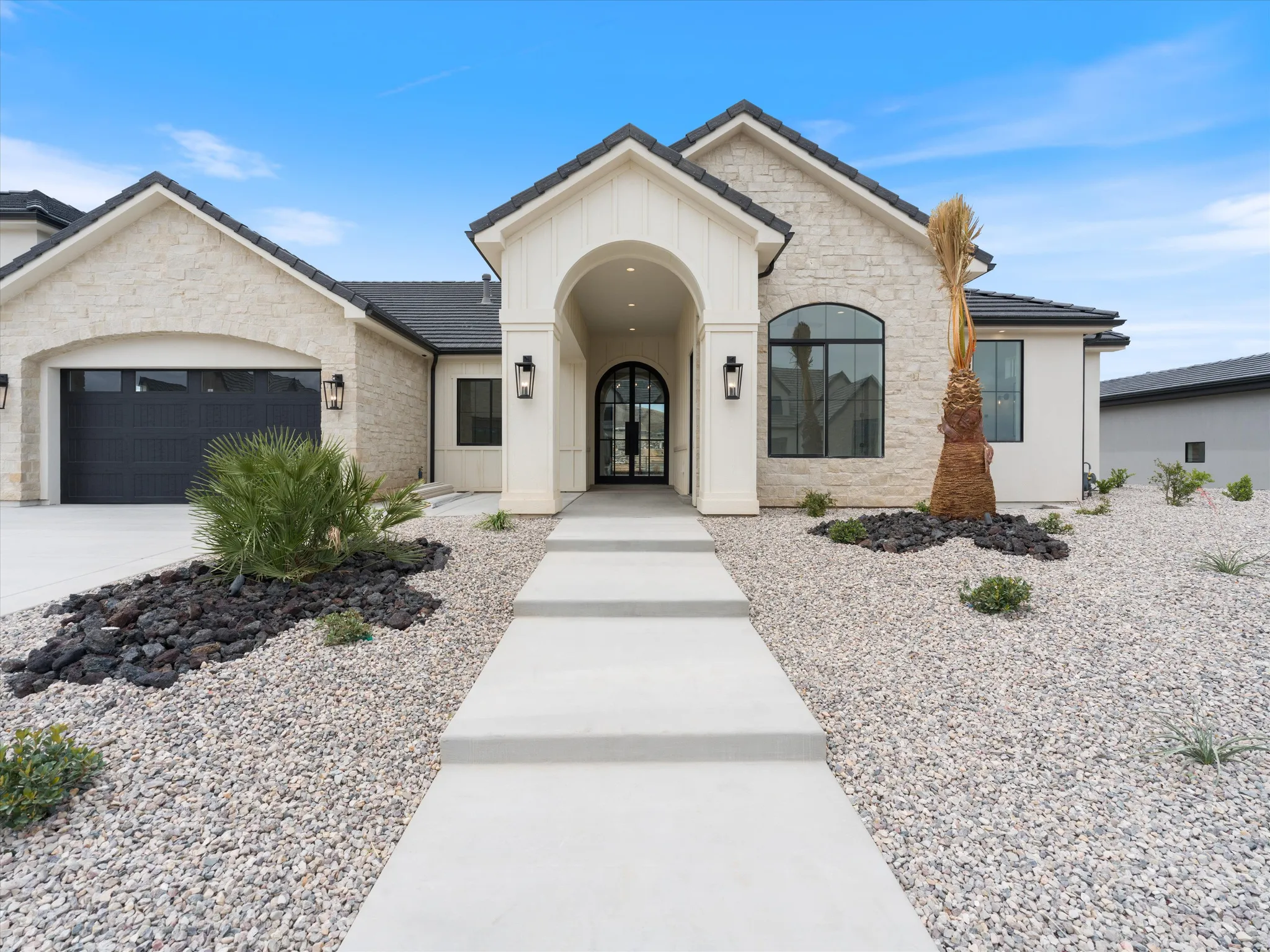 Contemporary exterior featuring a stone facade and stucco accents