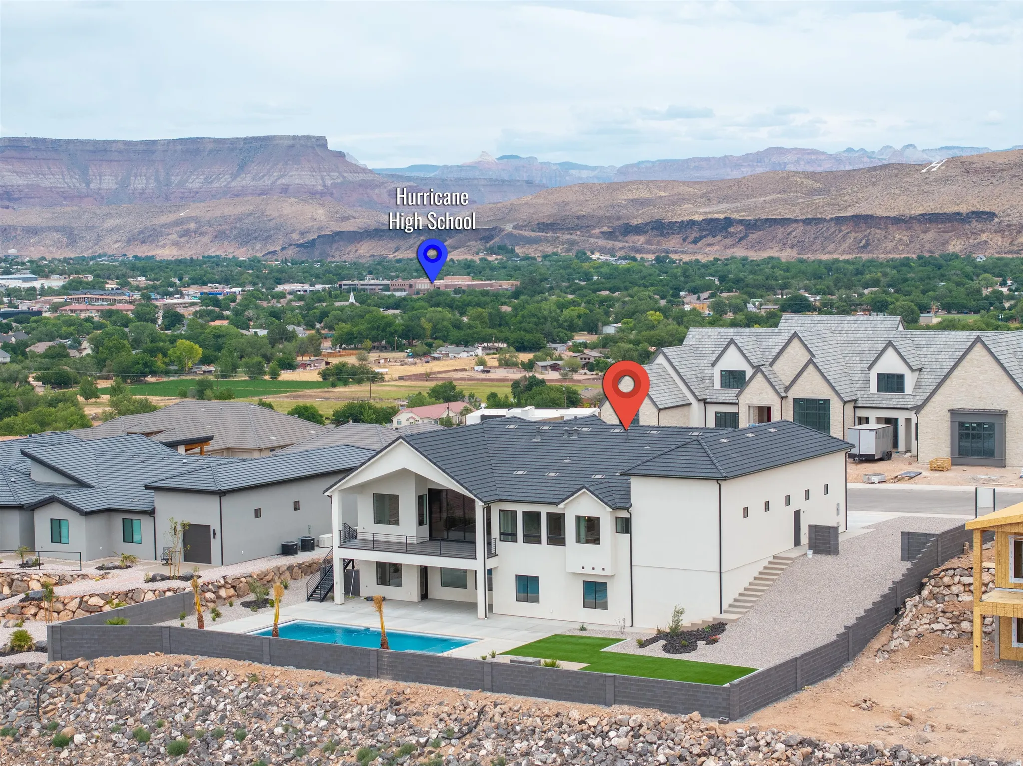 Modern two-story residence featuring a dark tile roof and light-colored stucco exterior