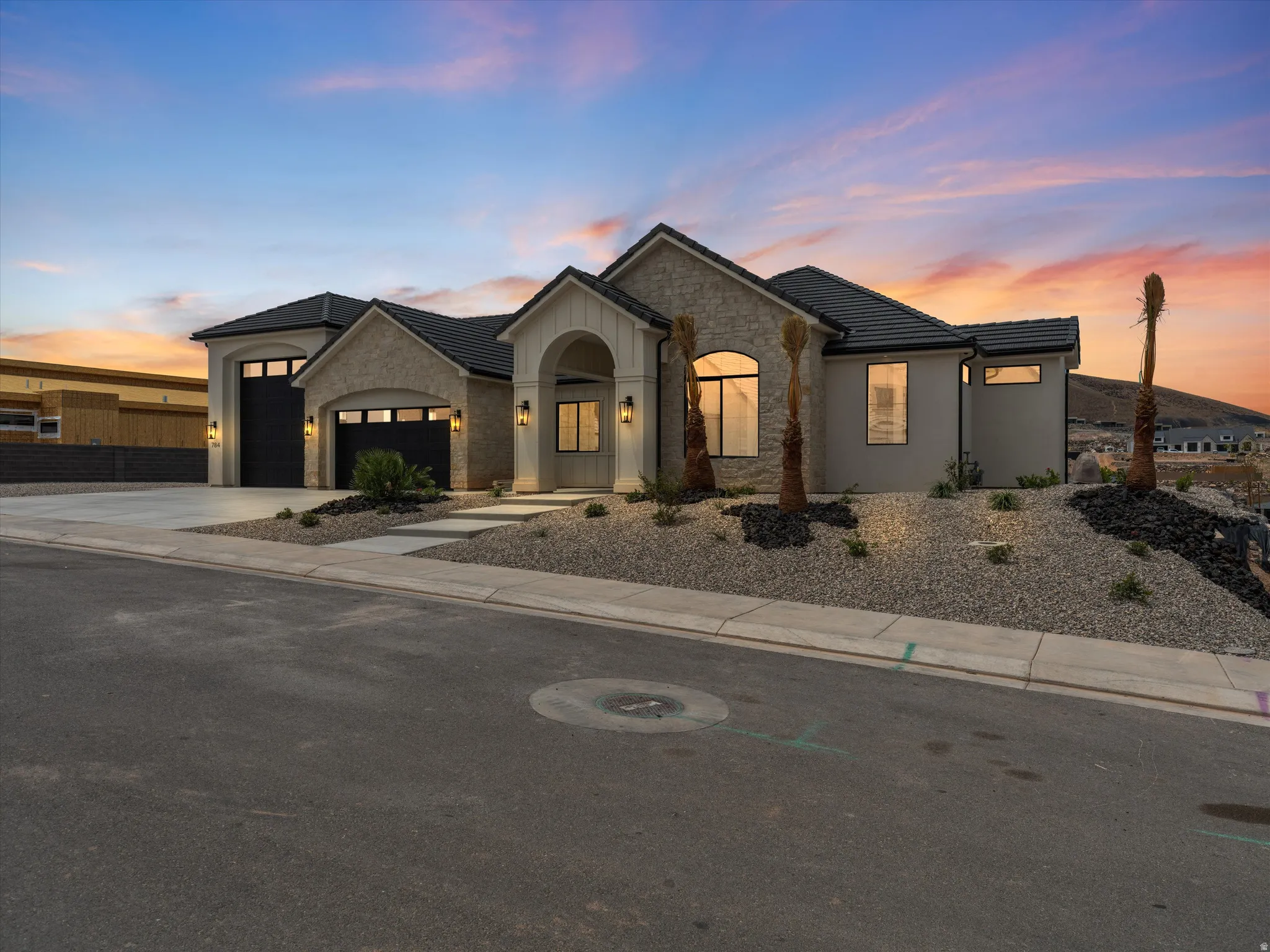 Modern stucco and stone exterior with arched entry