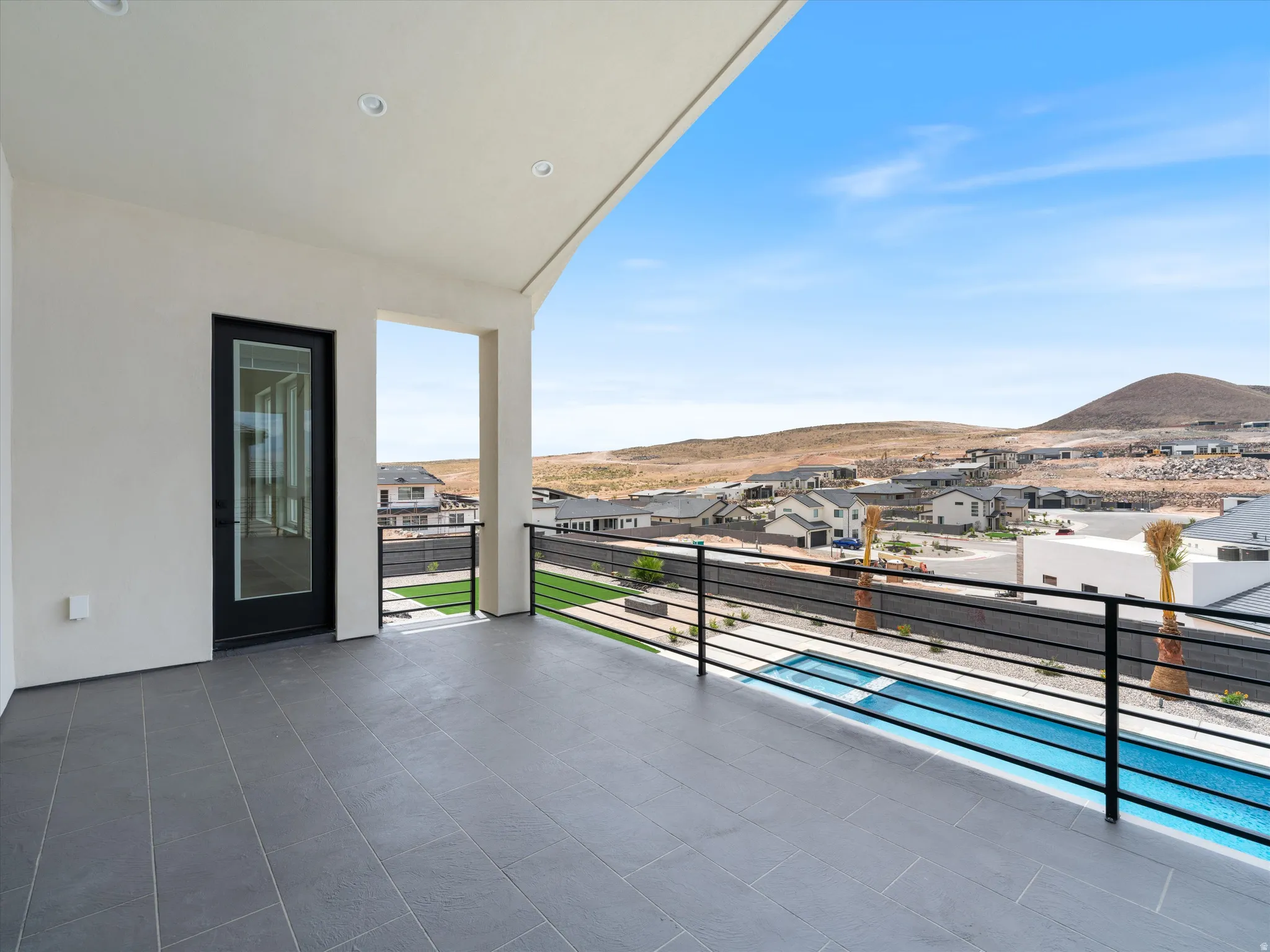 Covered outdoor patio with dark tile flooring
