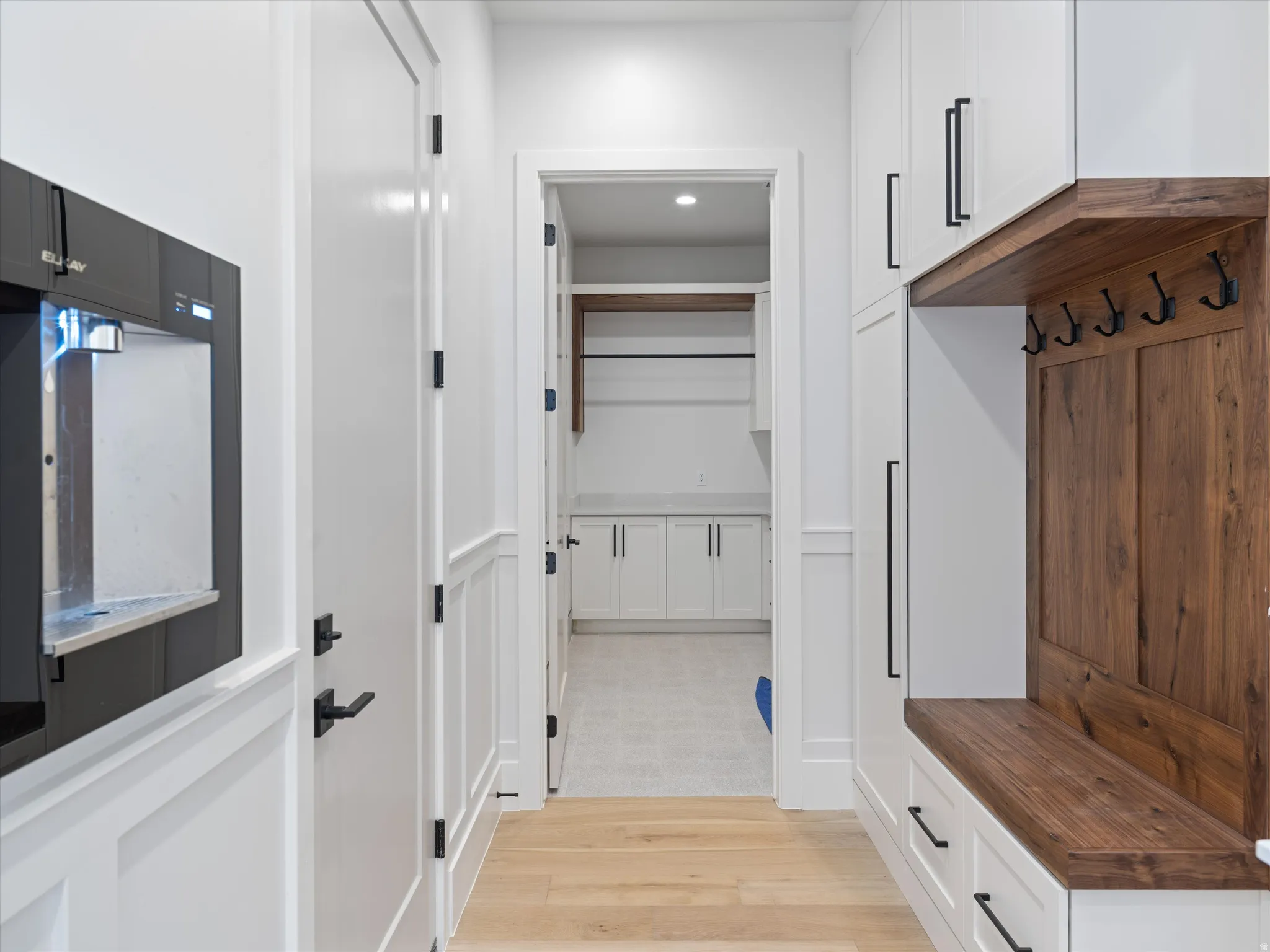 Entryway featuring wood-finish flooring and wainscoting
