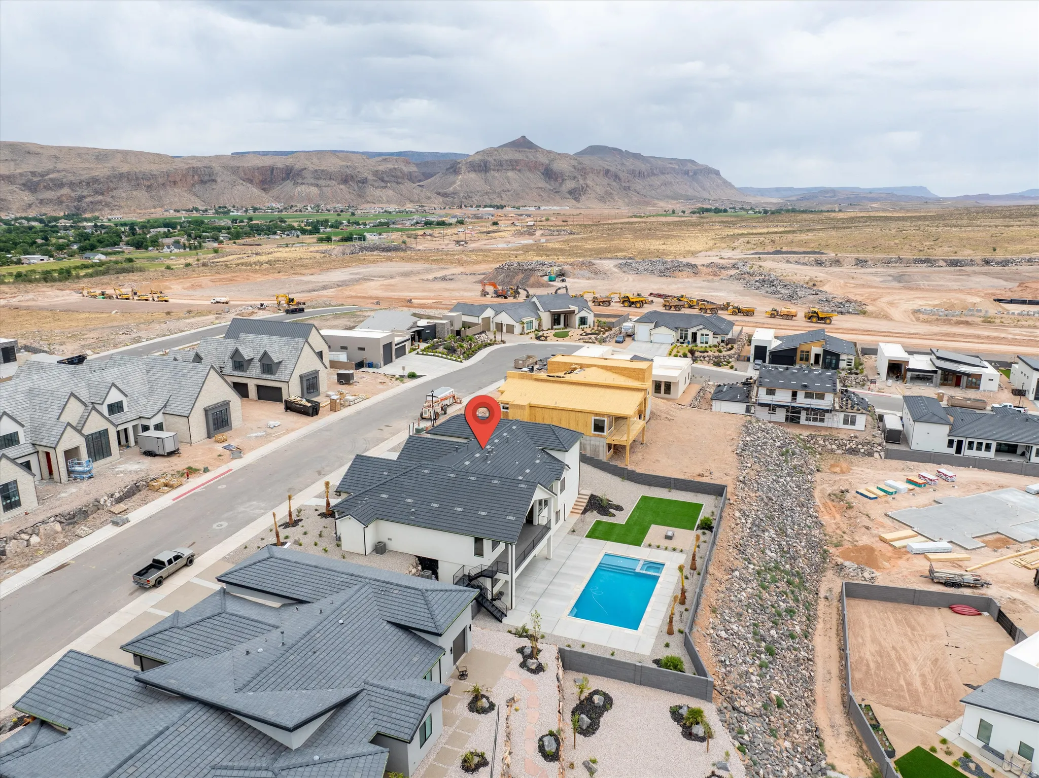 Contemporary residence featuring a private pool, artificial turf lawn, and a large patio area