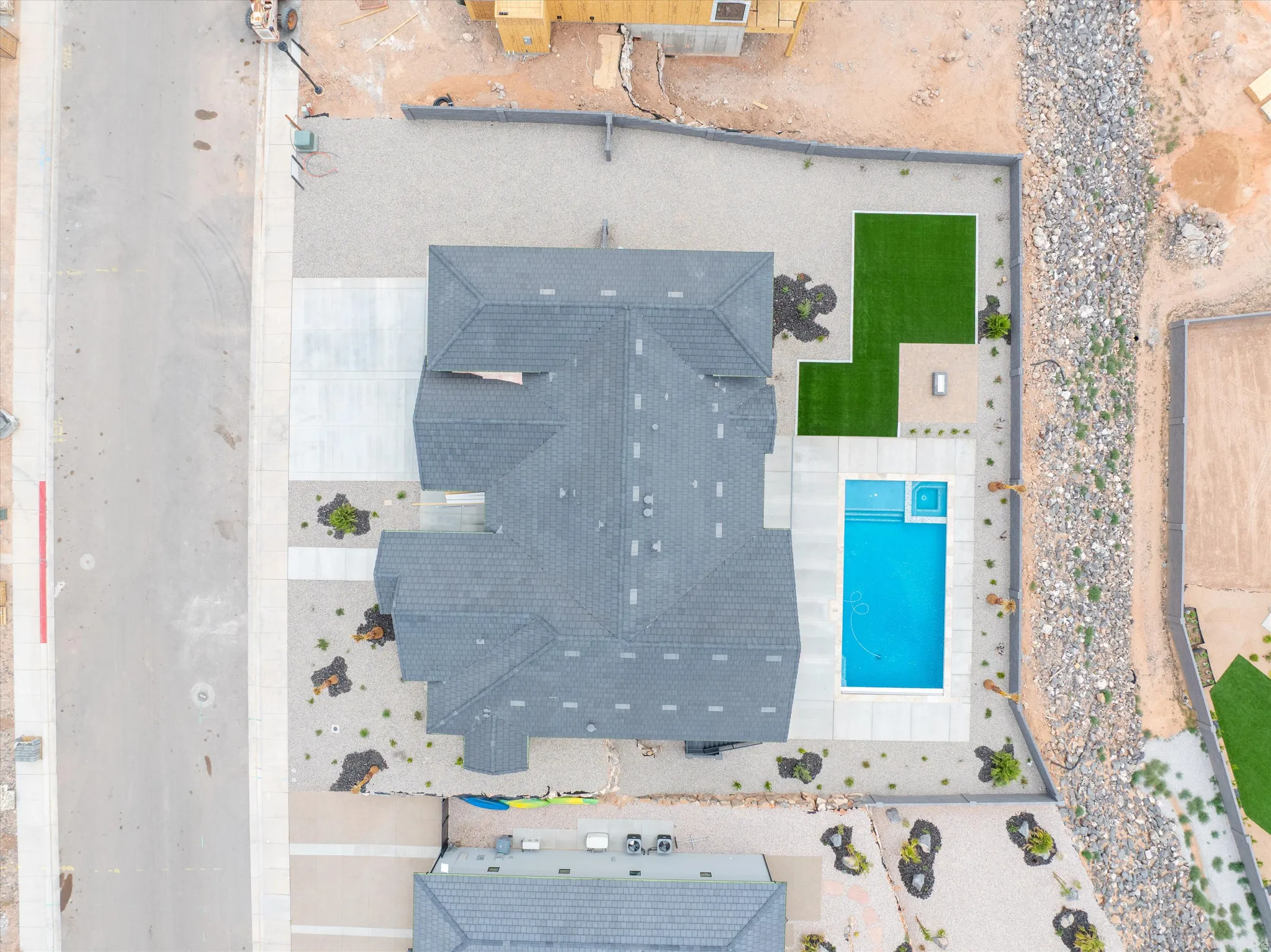 Pitched roof residence with a rectangular swimming pool featuring an integrated spa