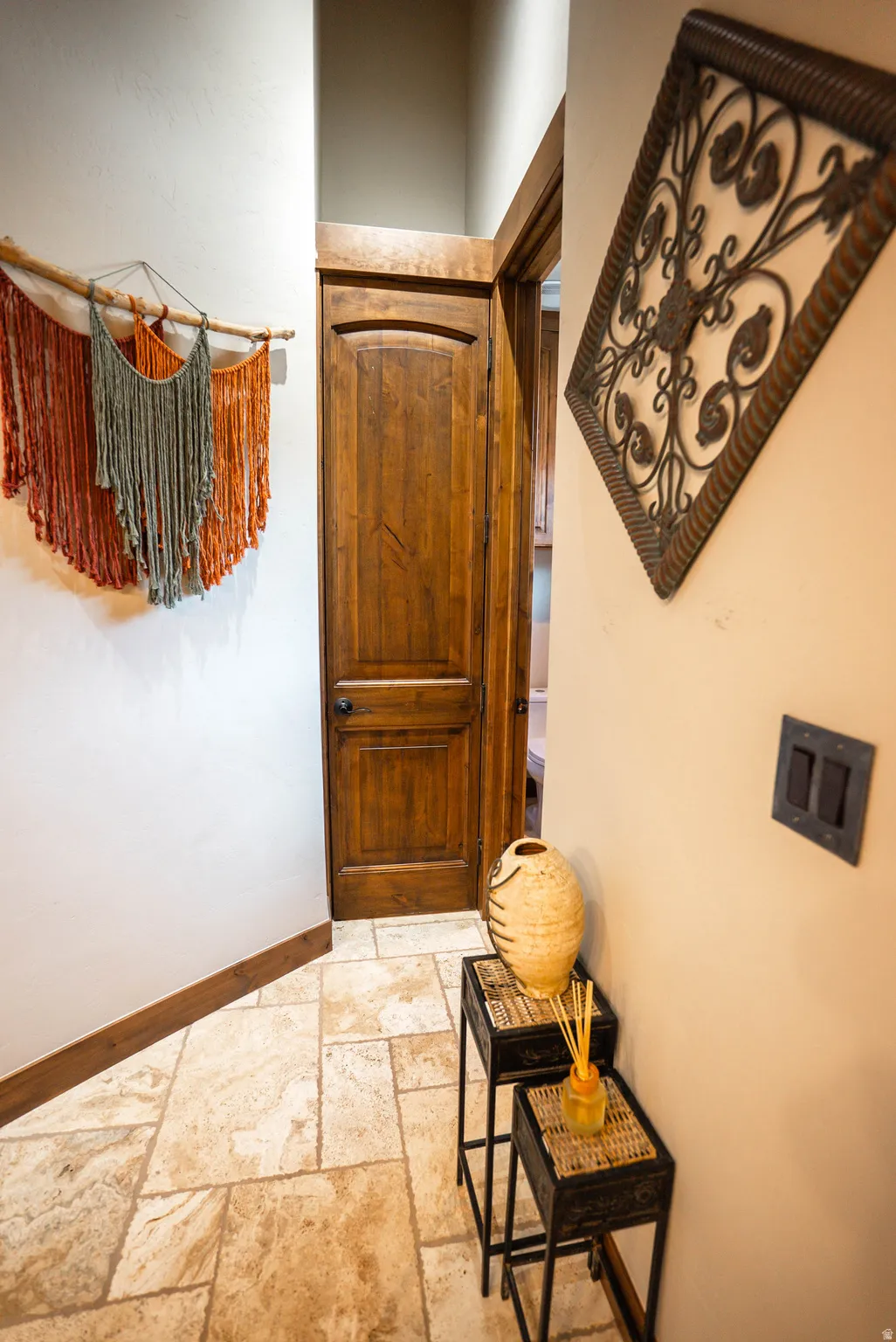 Wood-finish interior door with panel detailing and dark hardware
