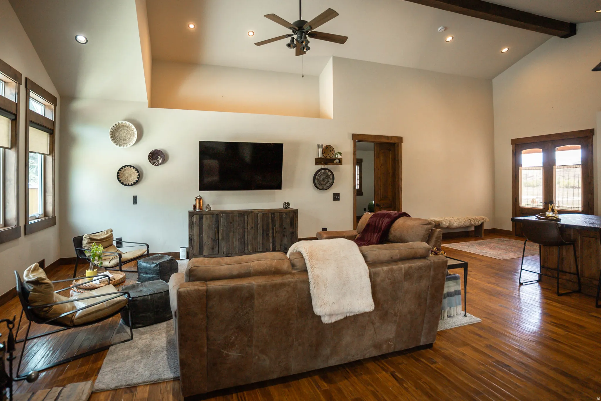 Vaulted ceilings featuring recessed lighting and a ceiling fan, wood-finish flooring, and exposed wood beams