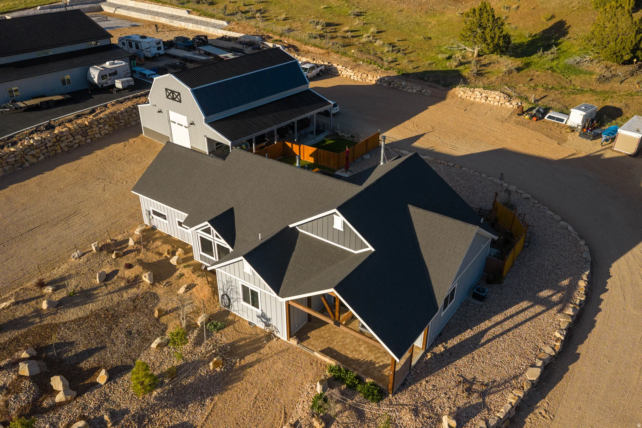 Modern farmhouse-style residence with a dark shingle roof and light-colored siding