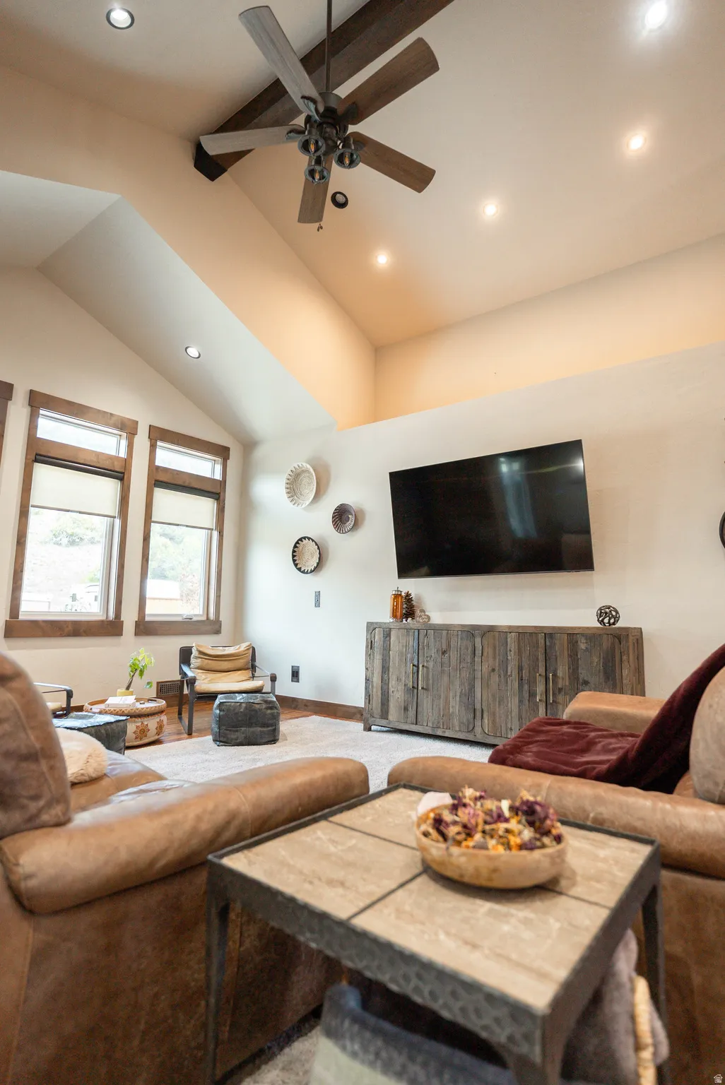 Vaulted ceiling with exposed beam and wood-finish ceiling fan