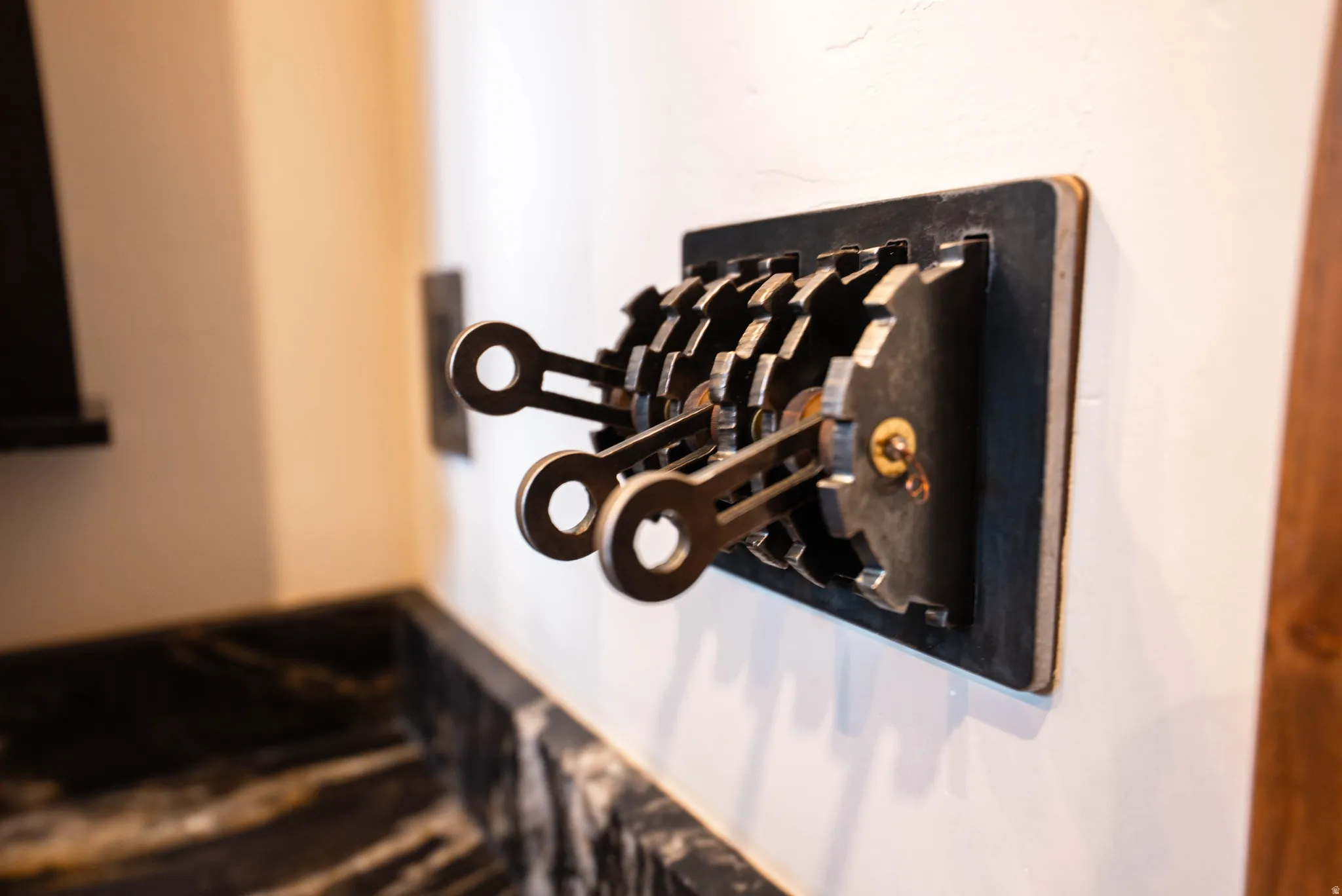 Custom wall-mounted light switch featuring industrial gear design and three levers