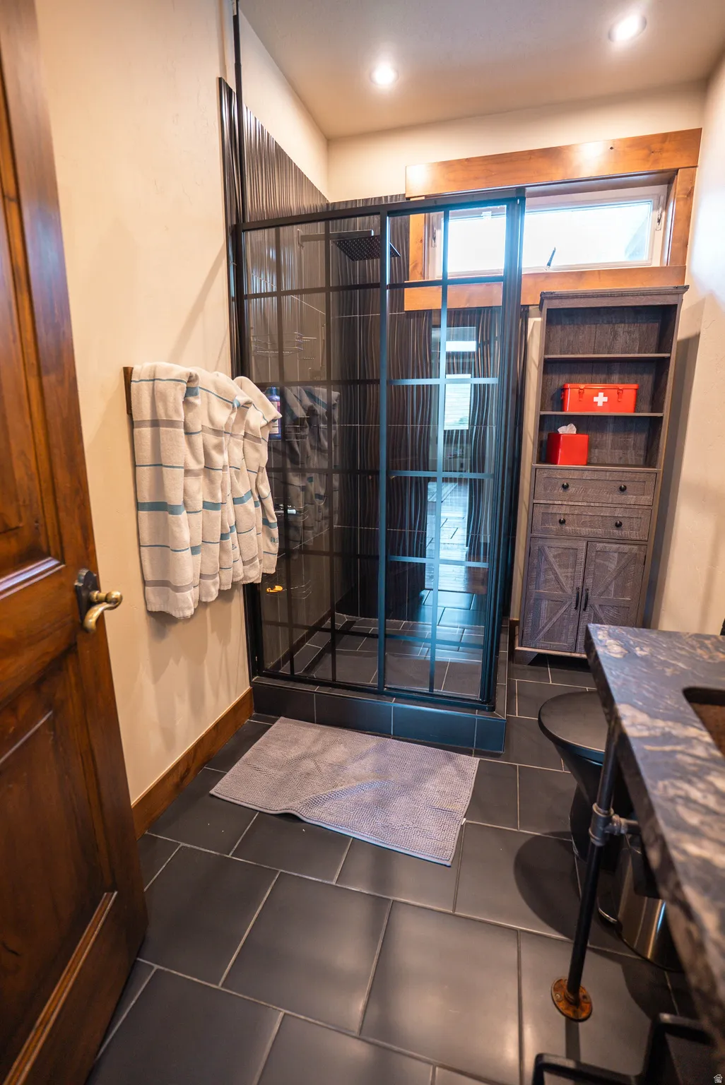 Modern bathroom with a black grid-patterned glass shower enclosure