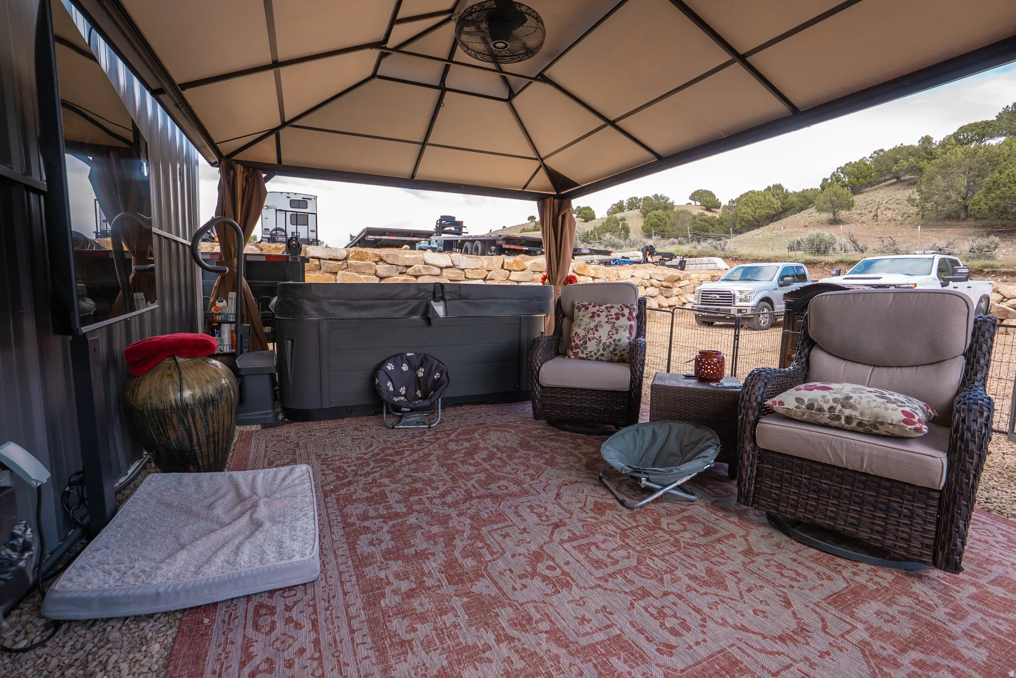 Covered outdoor patio area featuring a hot tub and a ceiling fan