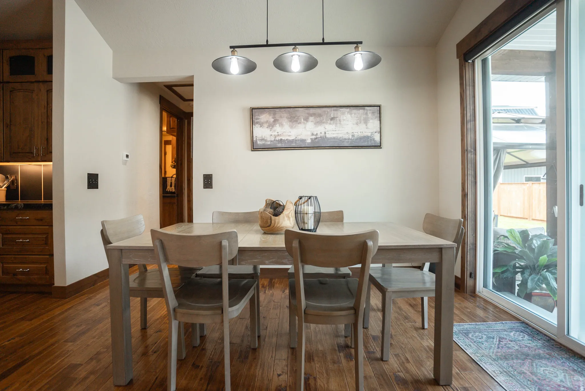 Warm wood-finish flooring complements the built-in wood cabinetry with under-cabinet lighting