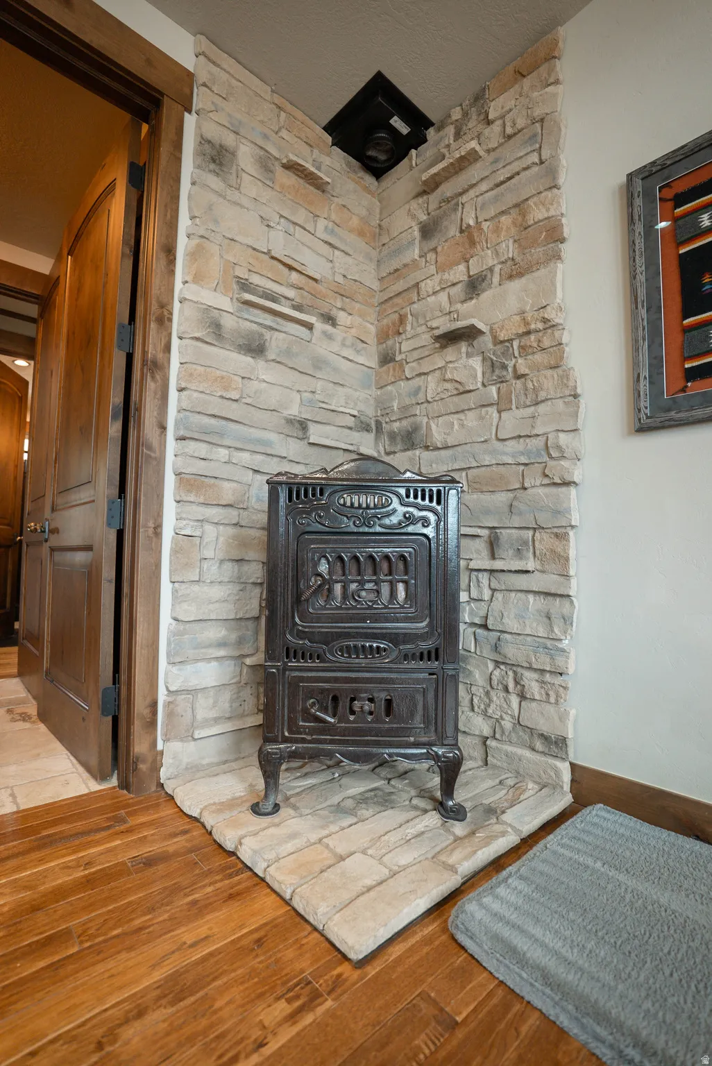 Cast iron stove with a stacked stone surround and hearth