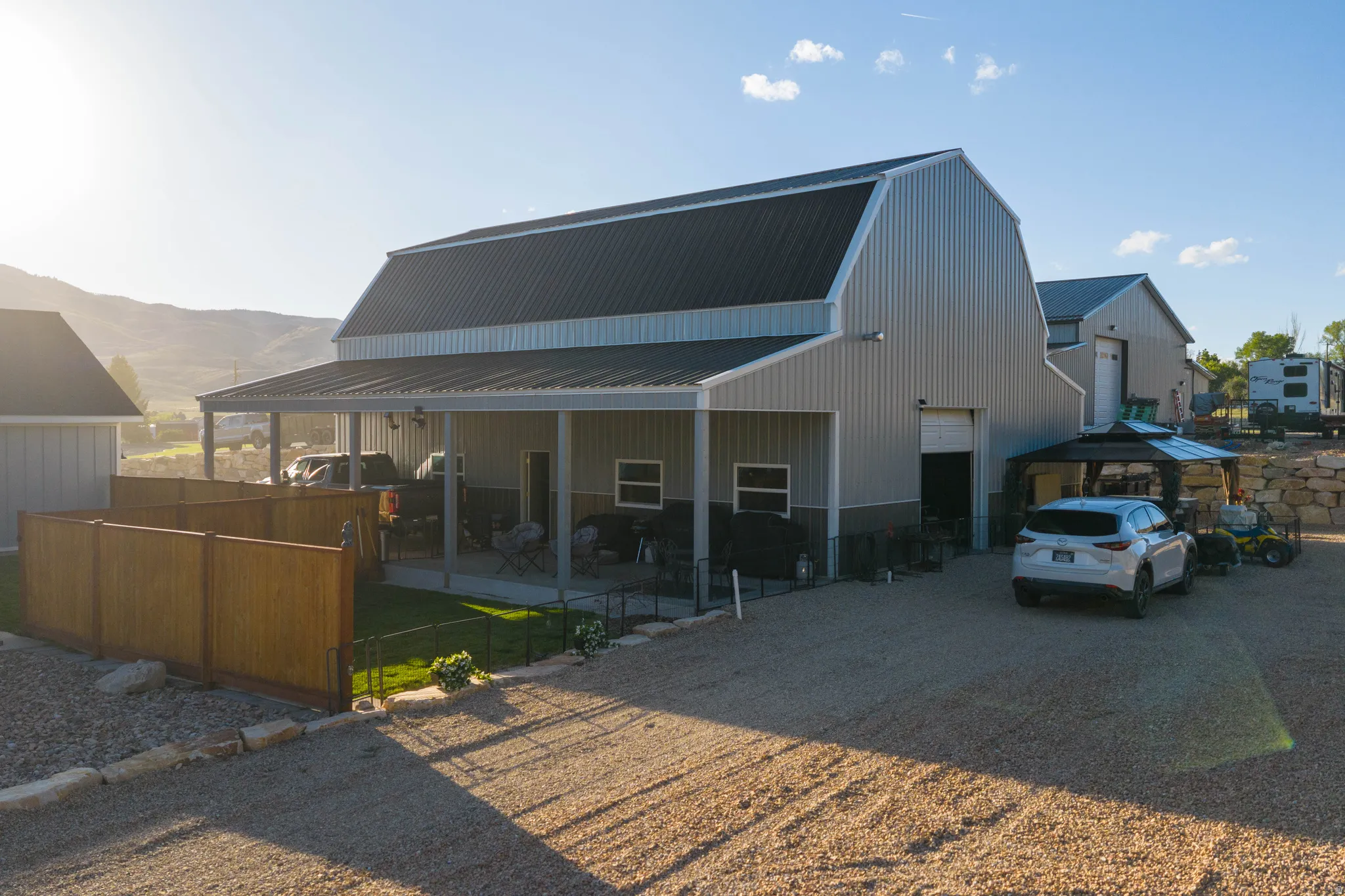 Metal-sided building with a gambrel roof and a covered patio