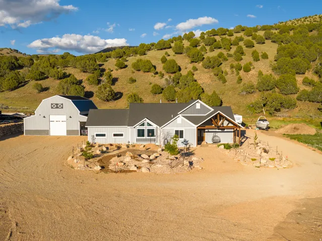 Ranch-style residence featuring light gray siding and a dark gray roof