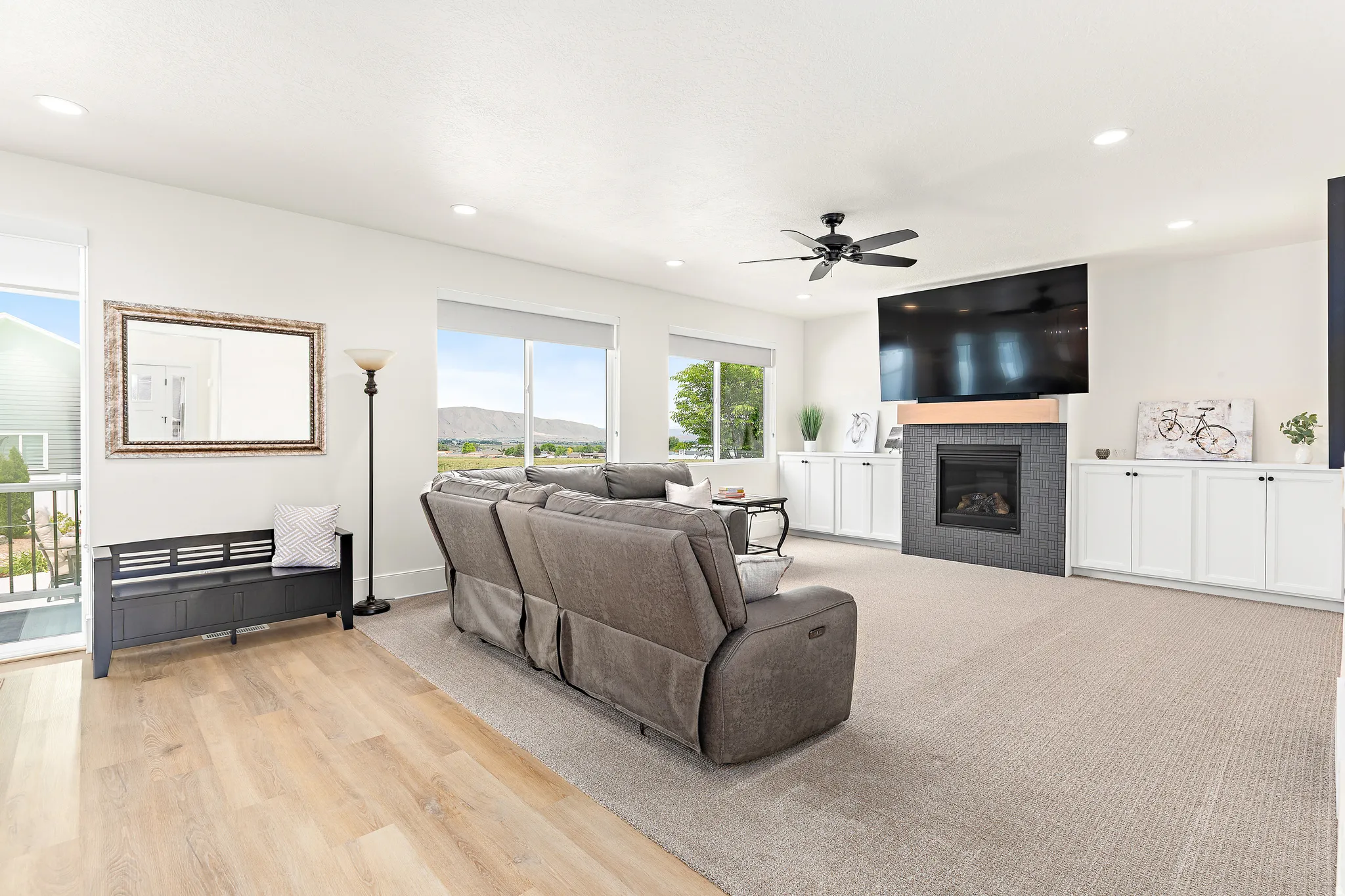 Spacious living area featuring a built-in fireplace with dark tile surround and wood mantel