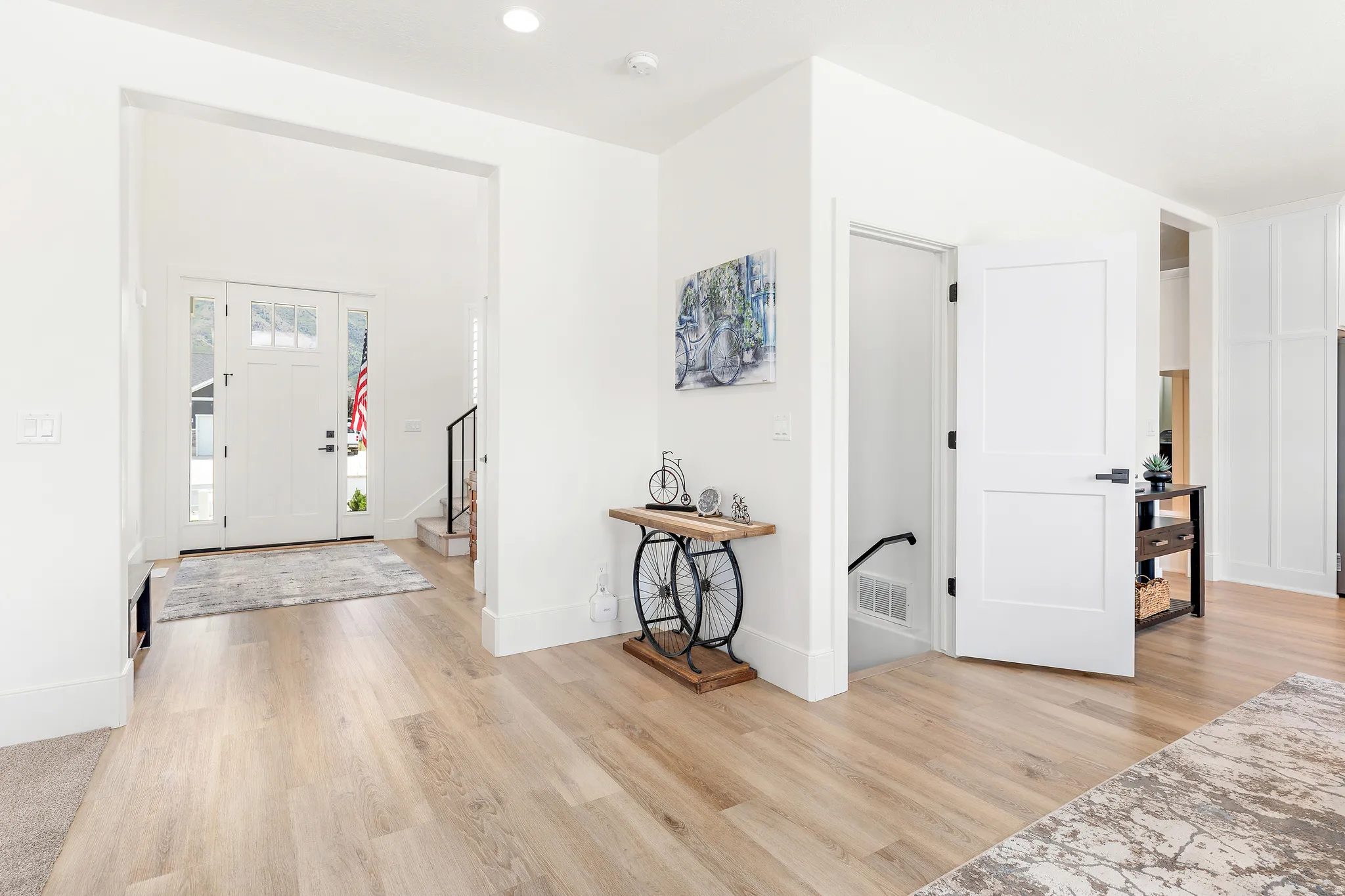 Bright entryway featuring light wood-finish flooring