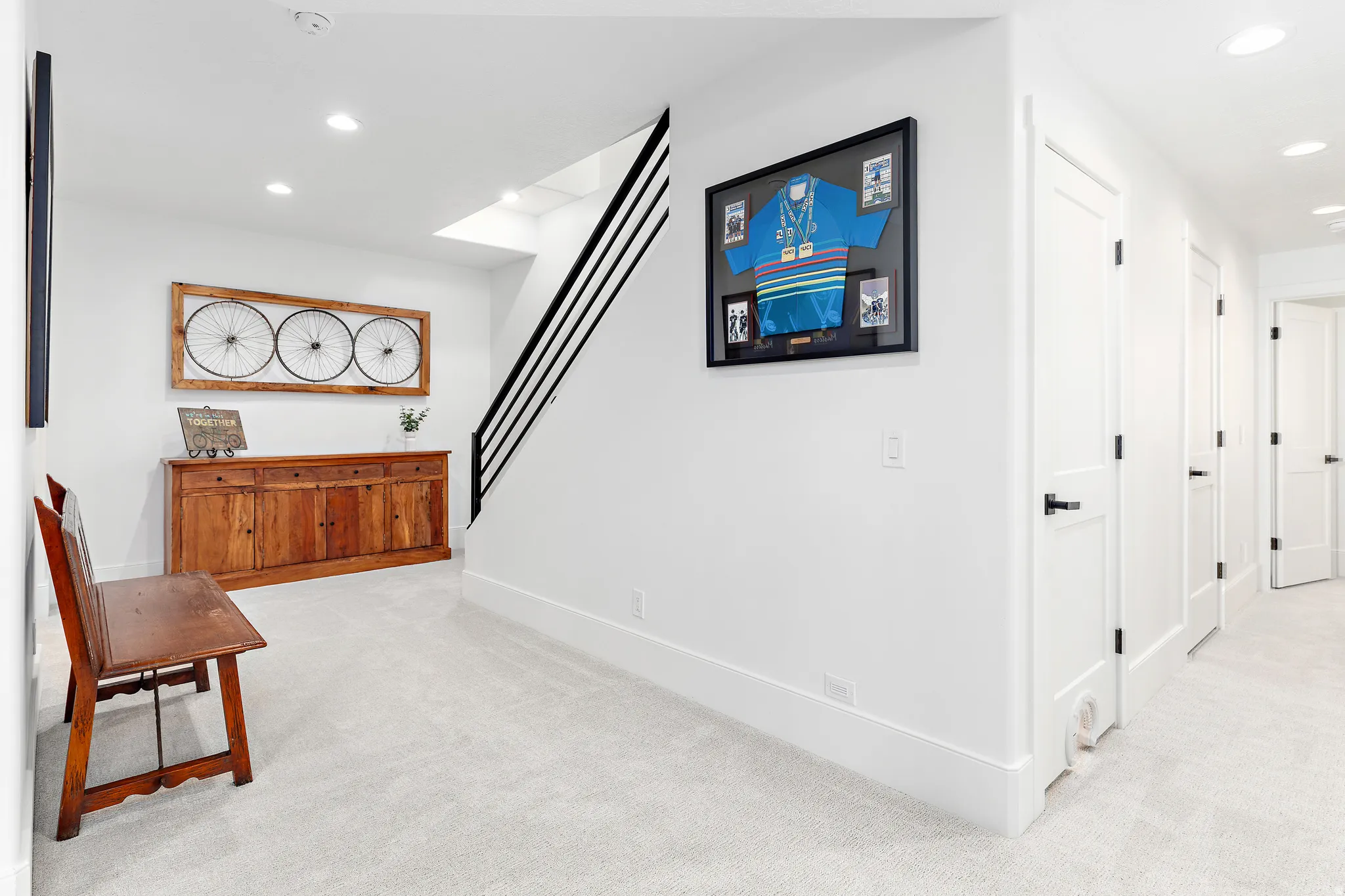 White walls with recessed lighting and light-colored carpeting throughout
