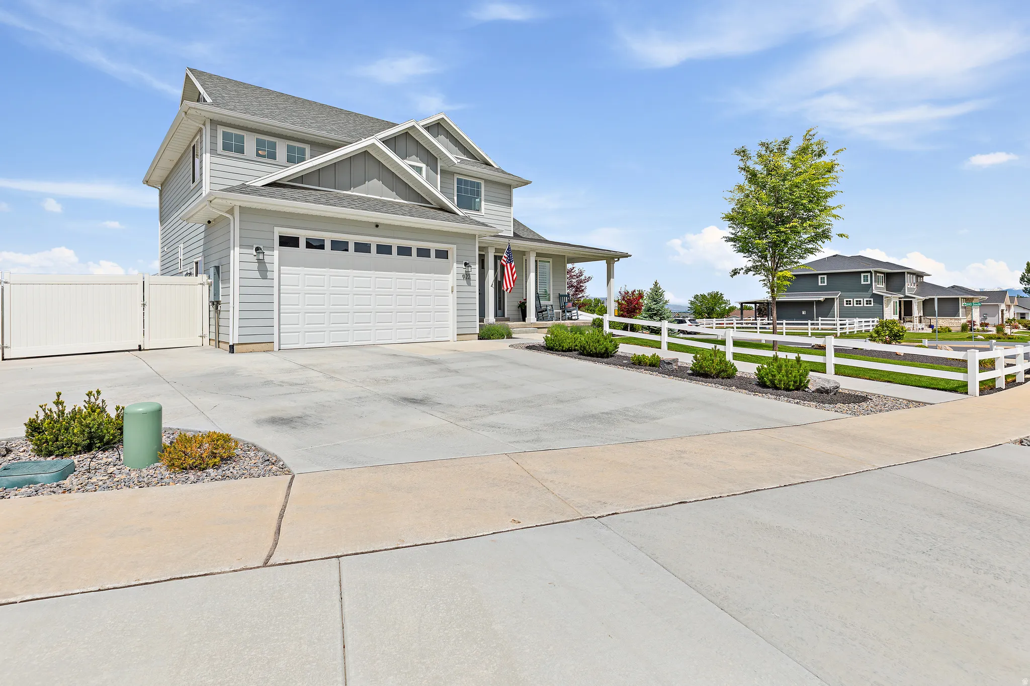 Light gray siding exterior with a two-car garage featuring a paneled door
