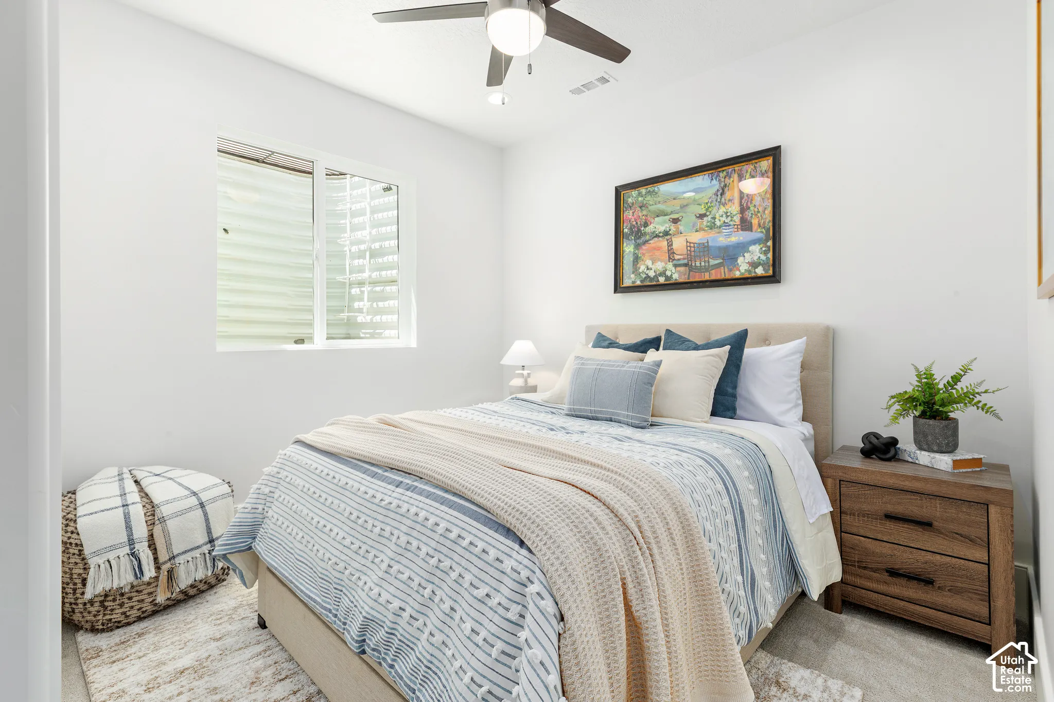 Bedroom featuring a ceiling fan with integrated lighting, a window with horizontal blinds, and light-toned walls