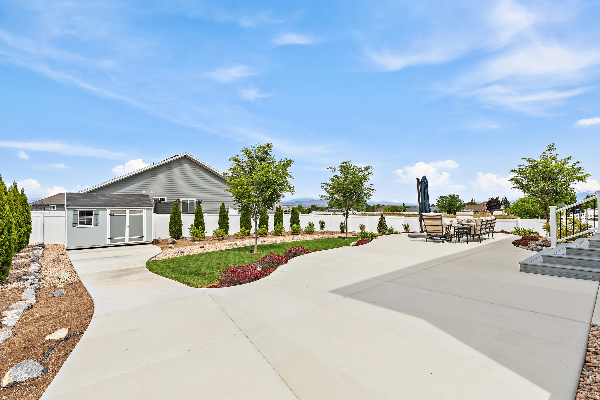 Expansive concrete patio with multiple levels and integrated steps