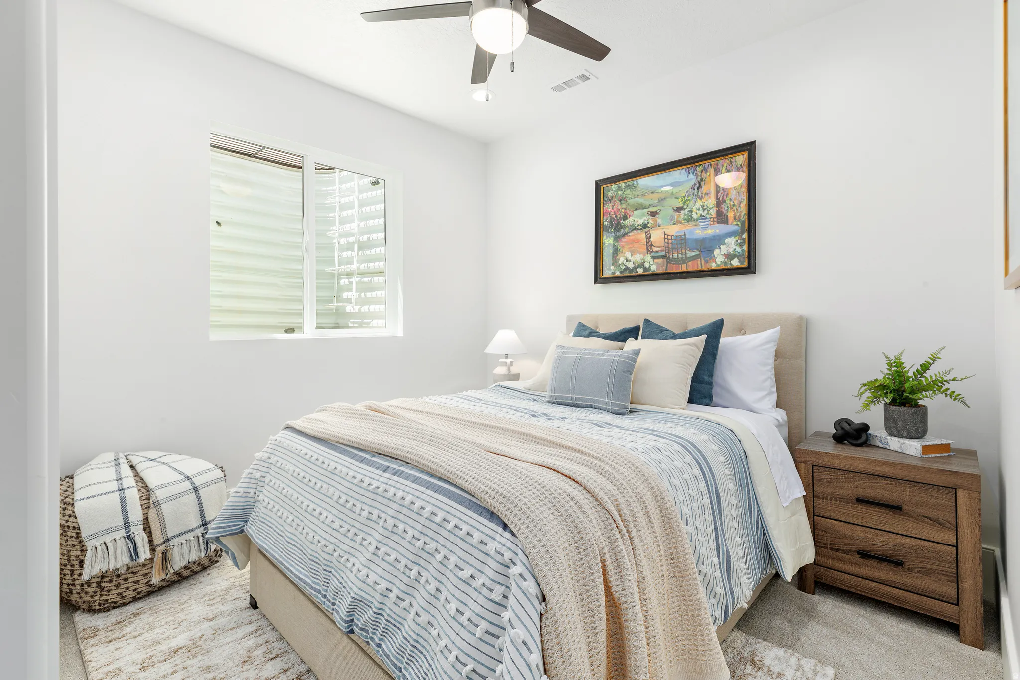 Bedroom featuring a ceiling fan with integrated lighting, a window with horizontal blinds, and light-toned walls