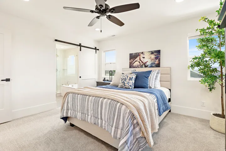 Spacious bedroom featuring recessed lighting, a ceiling fan, and carpeted flooring