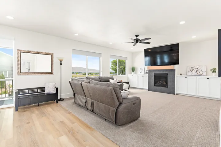 Spacious living area featuring a built-in fireplace with dark tile surround and wood mantel