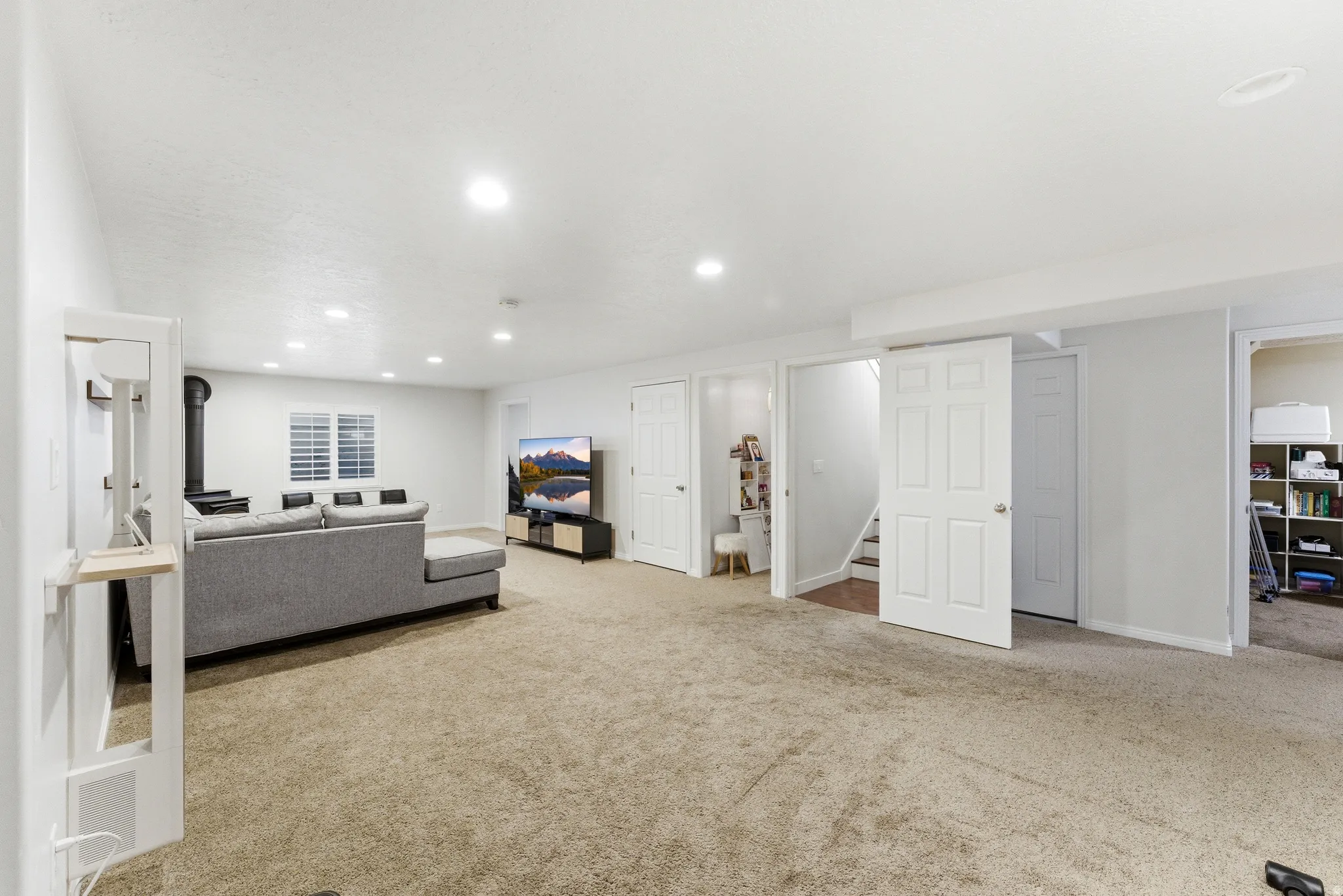 Carpeted room with recessed lighting and white walls