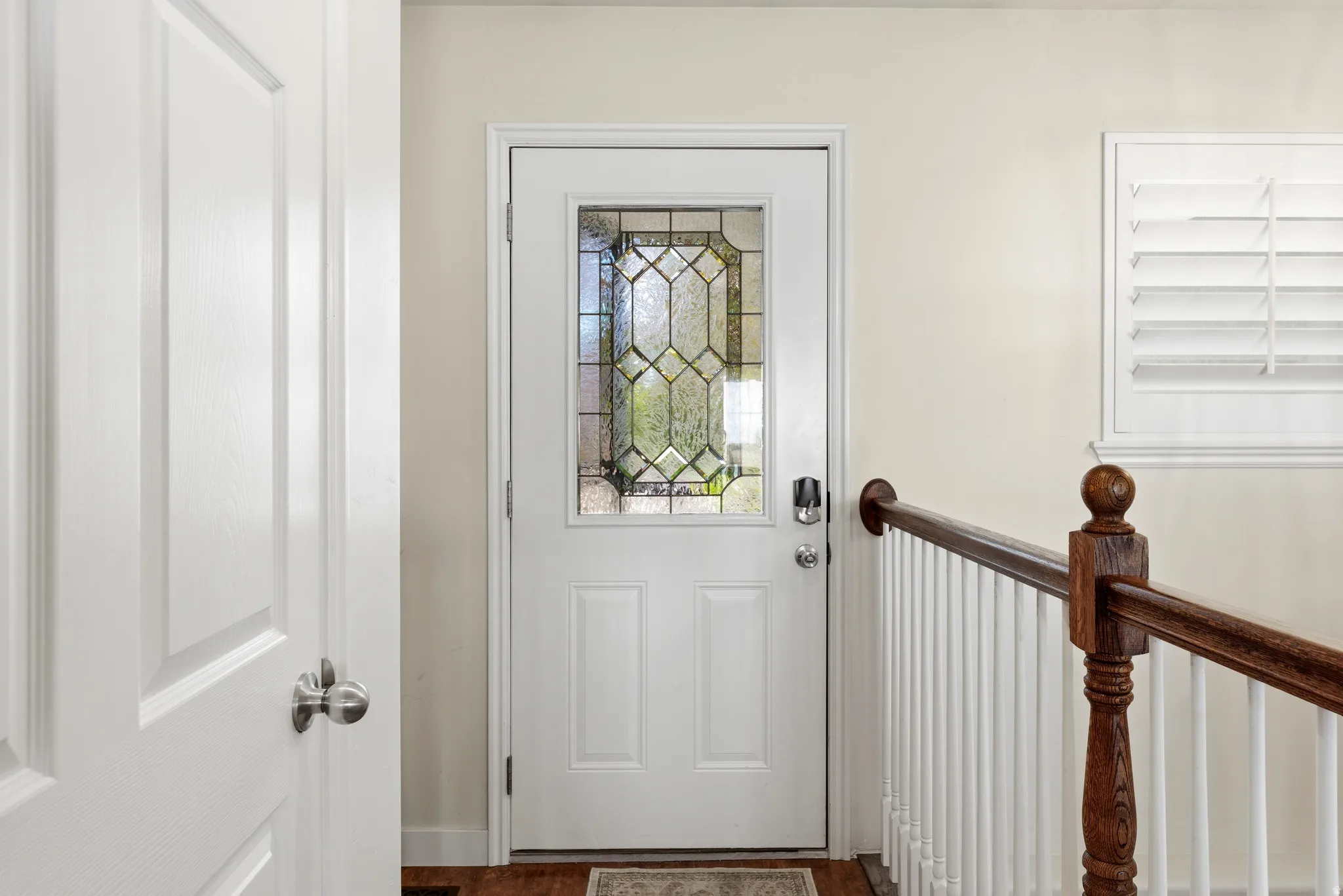 Entry door with decorative glass insert and smart lock system