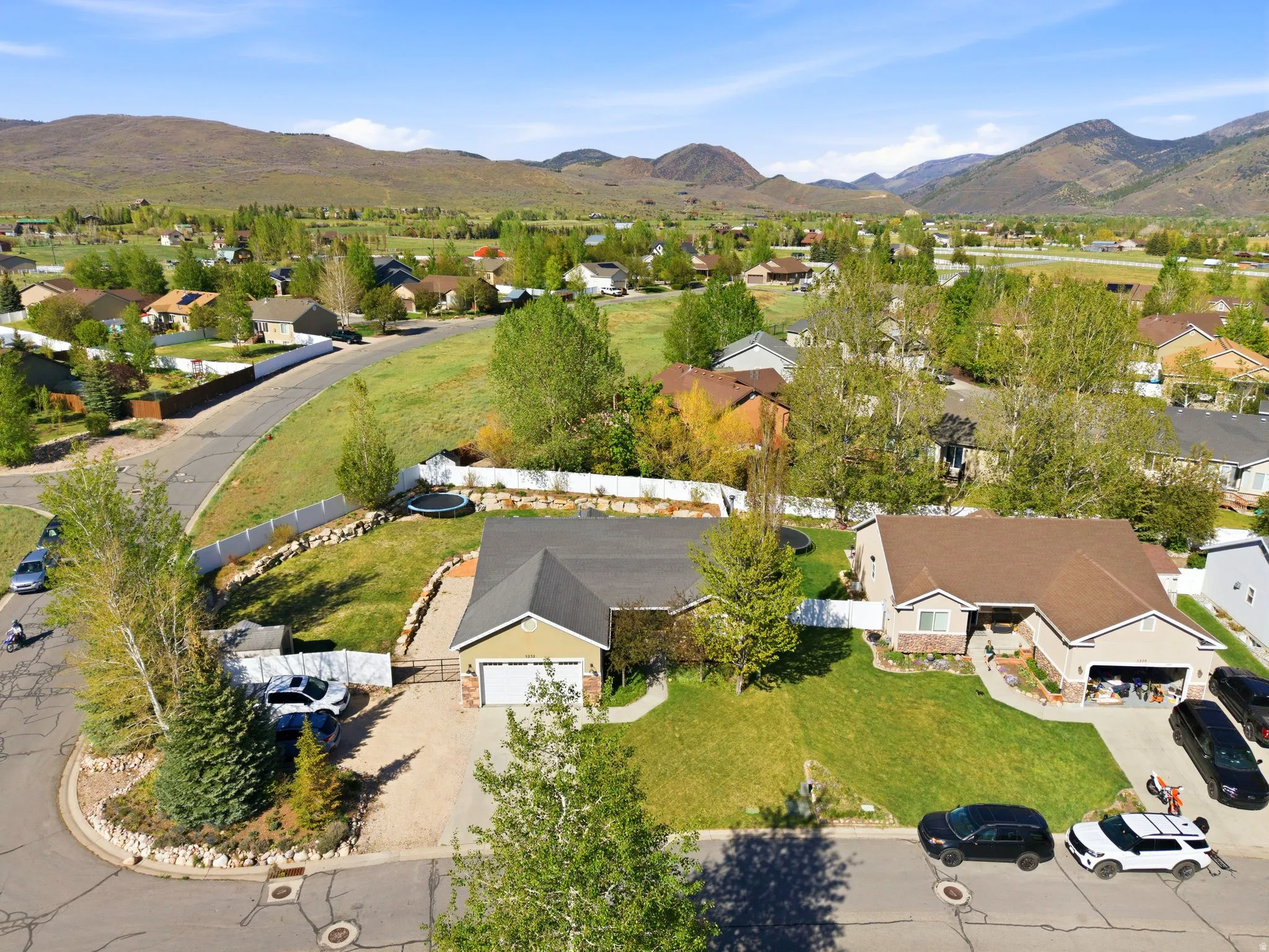 Ranch-style residence featuring a two-car garage and a paved driveway