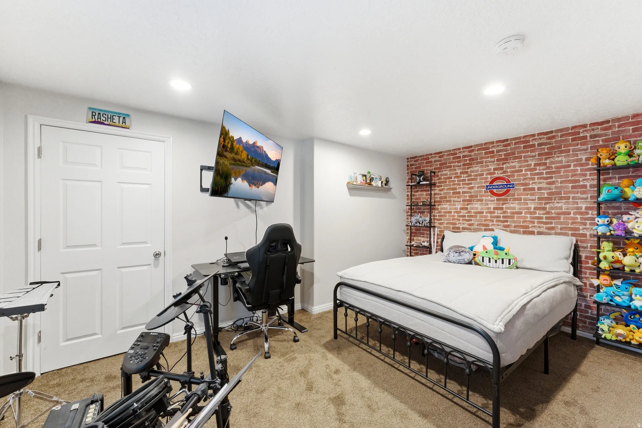 Bedroom featuring a textured accent wall, recessed lighting, and carpeted flooring