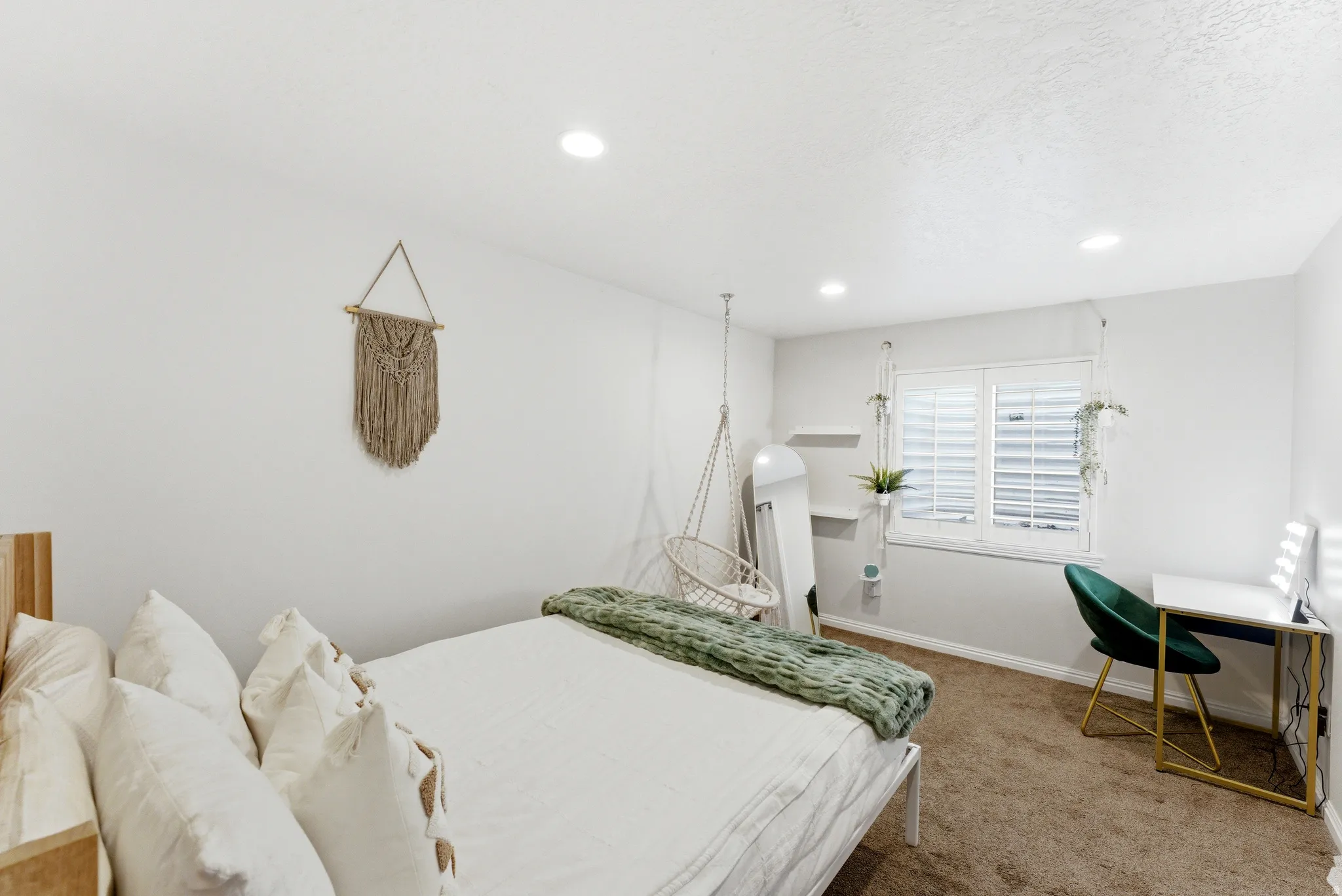 Bedroom featuring recessed lighting, a window with plantation shutters, neutral wall tones, and carpet flooring