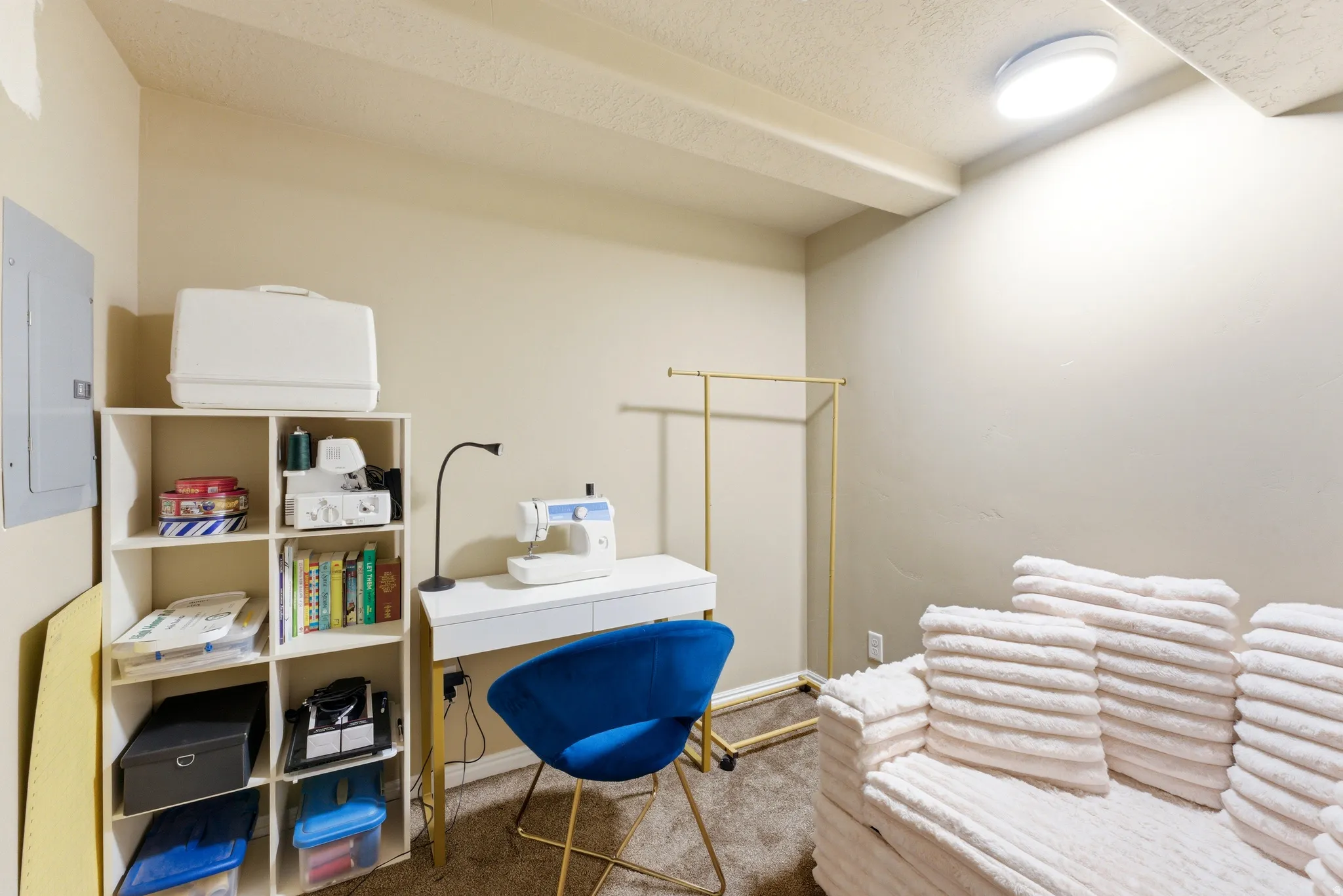 Versatile room featuring a light beige wall color, exposed ceiling beams, and a flush-mounted ceiling light