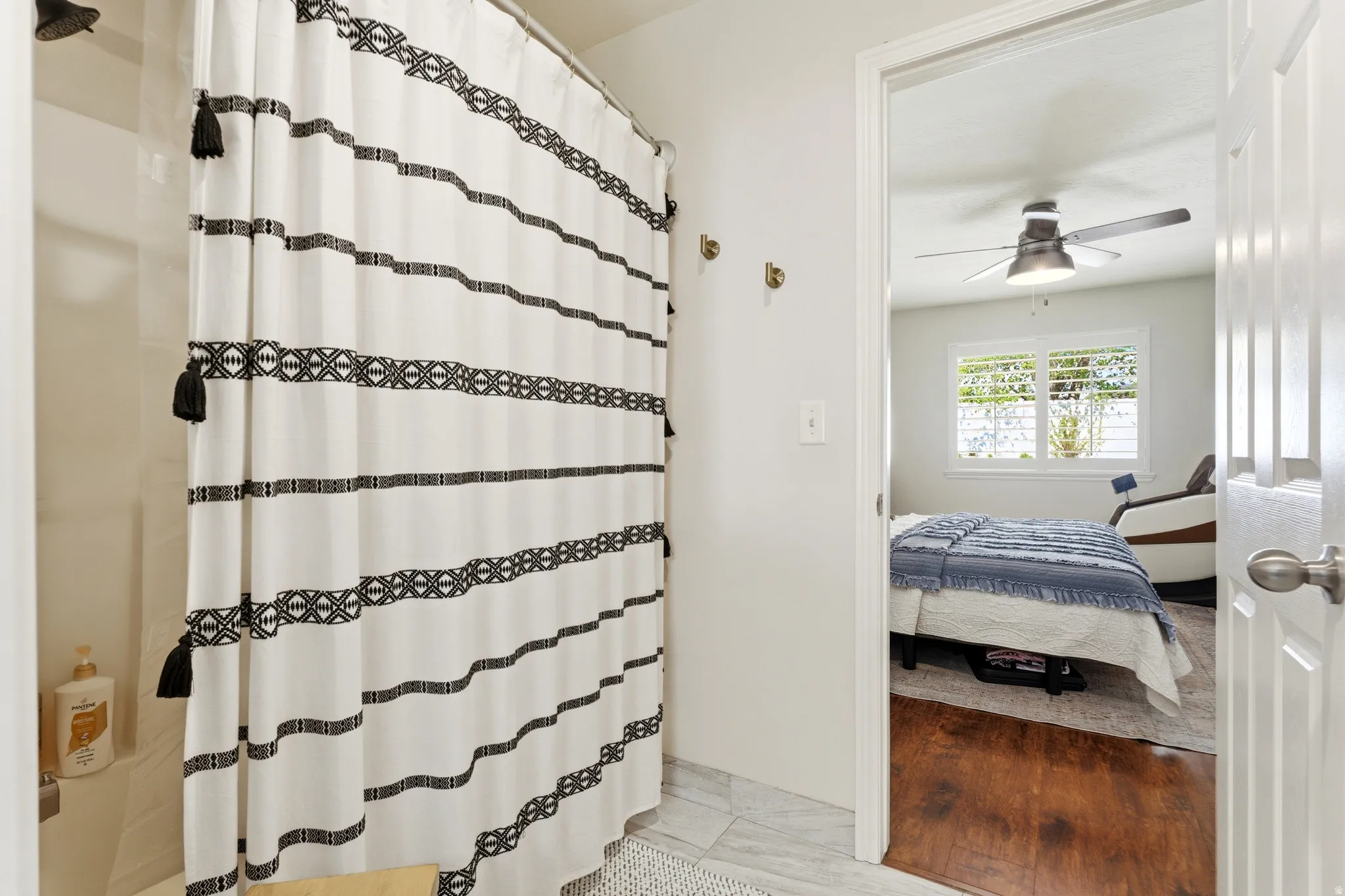 Bathroom featuring a shower/tub combination with white tile surround
