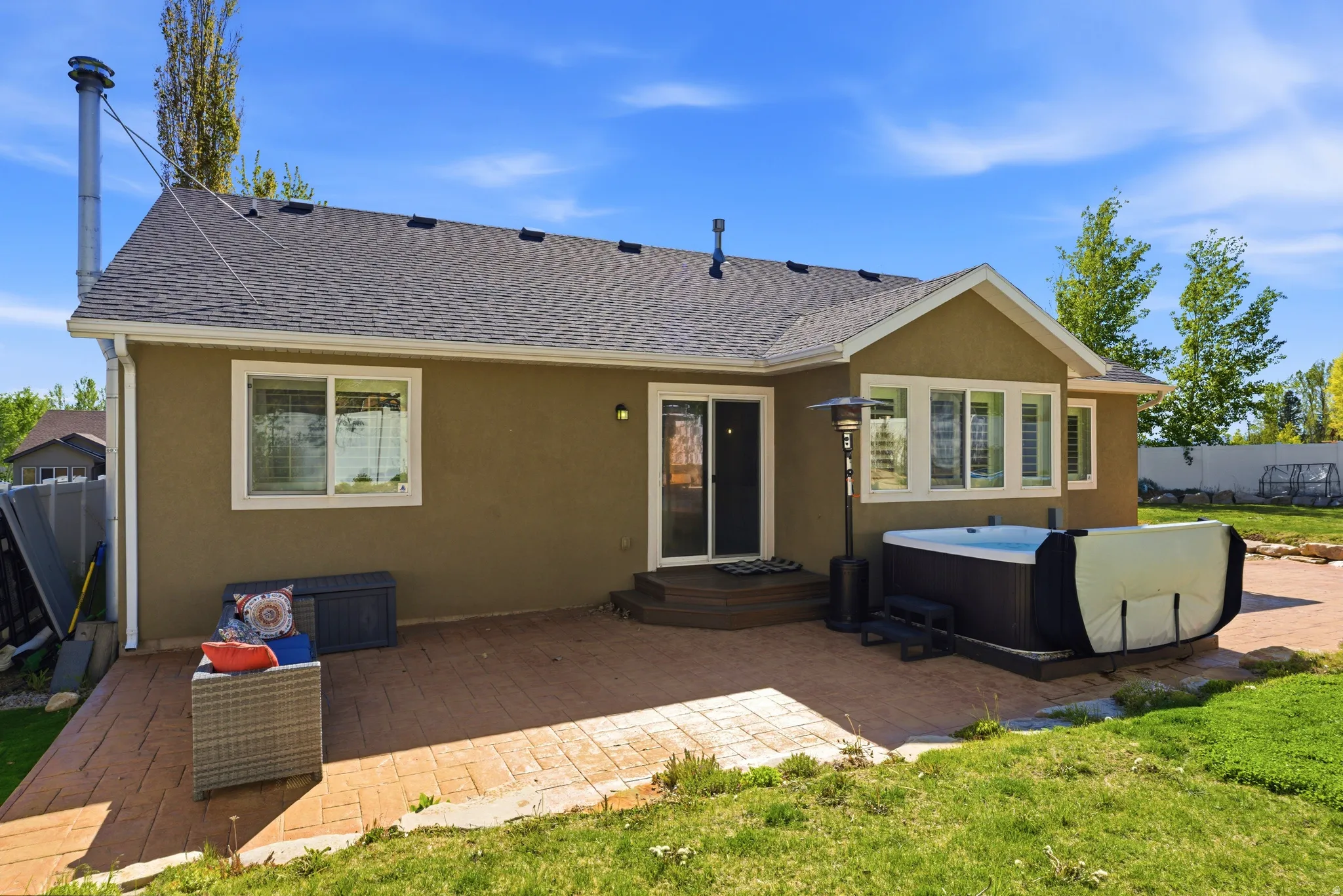 Expansive stamped concrete patio with direct access to the interior via a sliding glass door