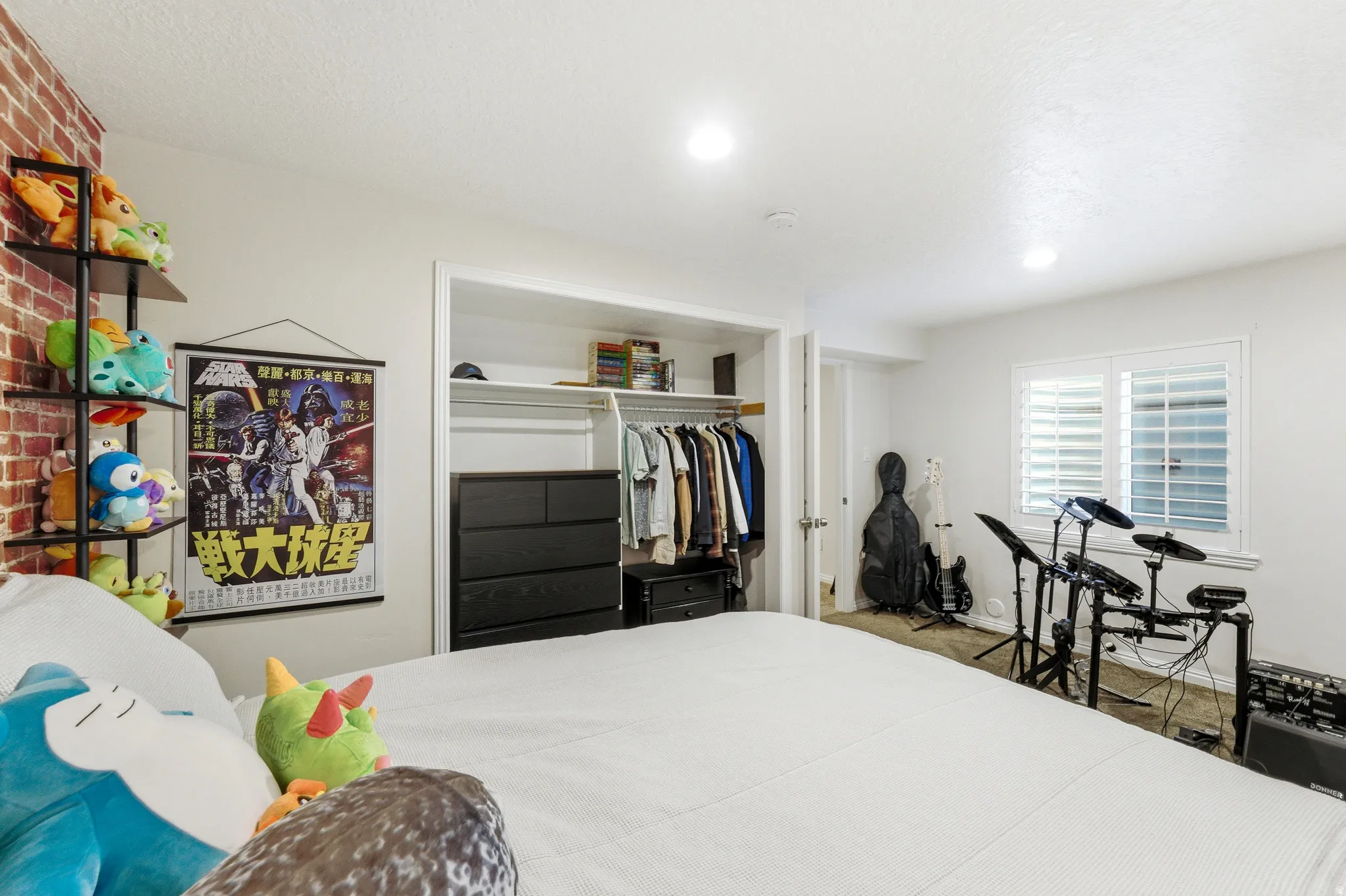 Bedroom featuring a built-in closet with shelving and hanging rods