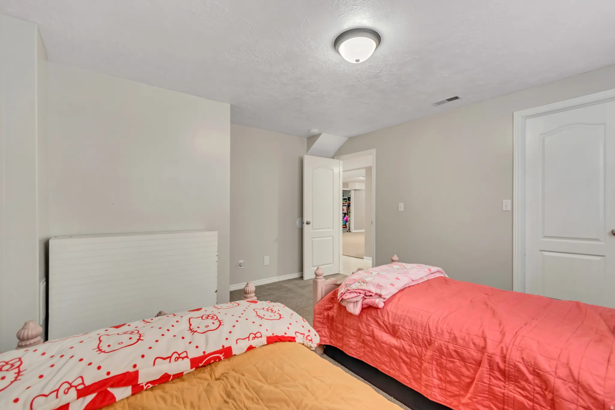 Neutral-toned interior room with light gray walls and a textured ceiling