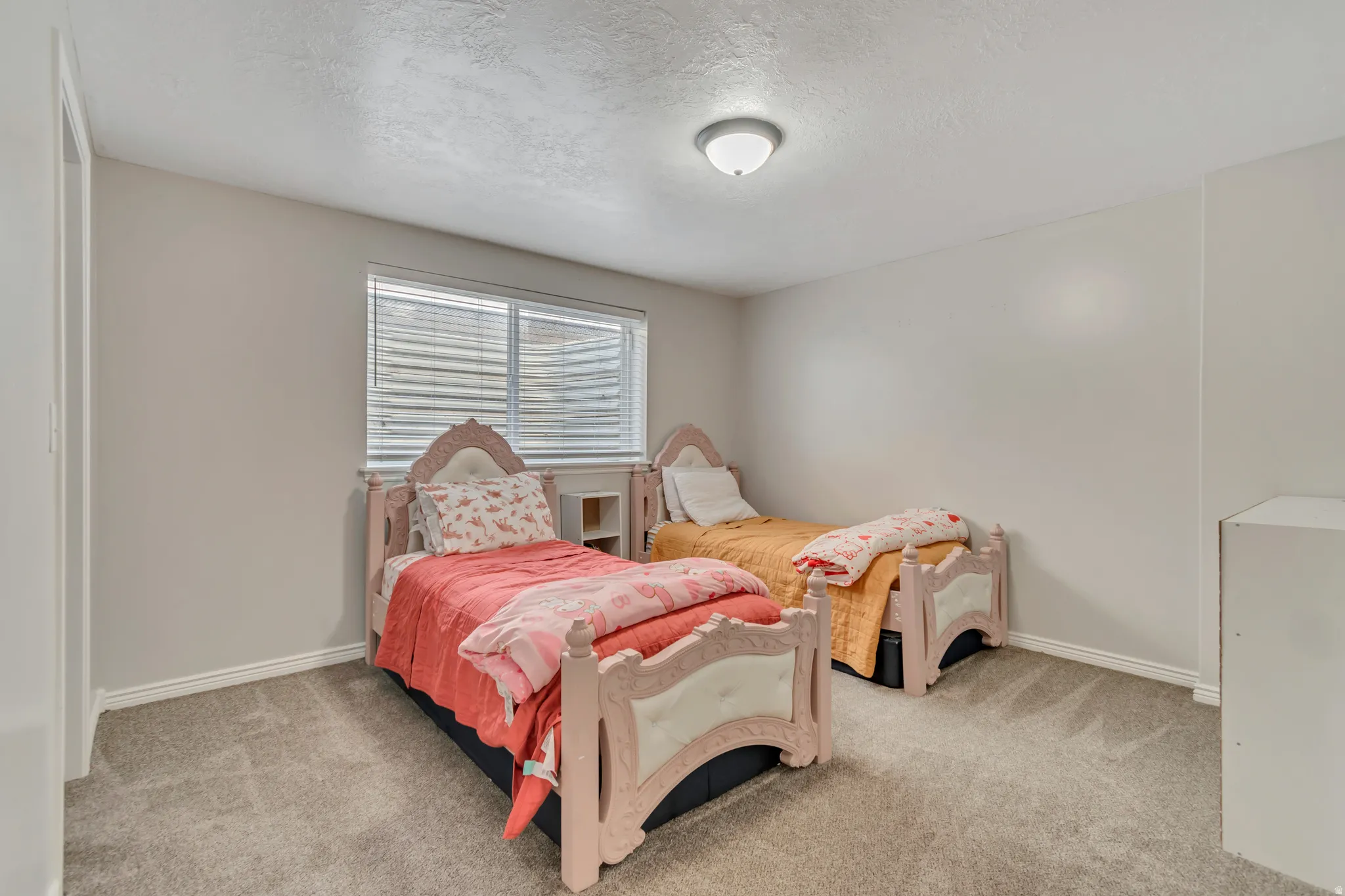 Neutral-toned walls complement the gray carpeting