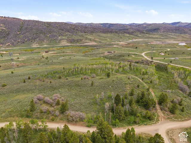 Expansive rural landscape featuring rolling hills and abundant natural vegetation