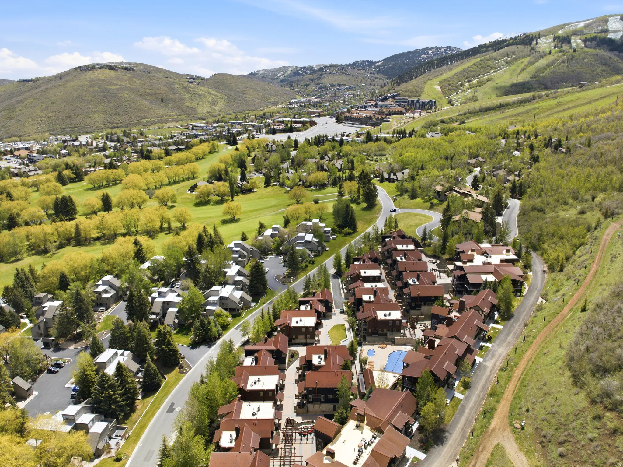 Aerial perspective showcasing a residential community amidst a mountainous landscape