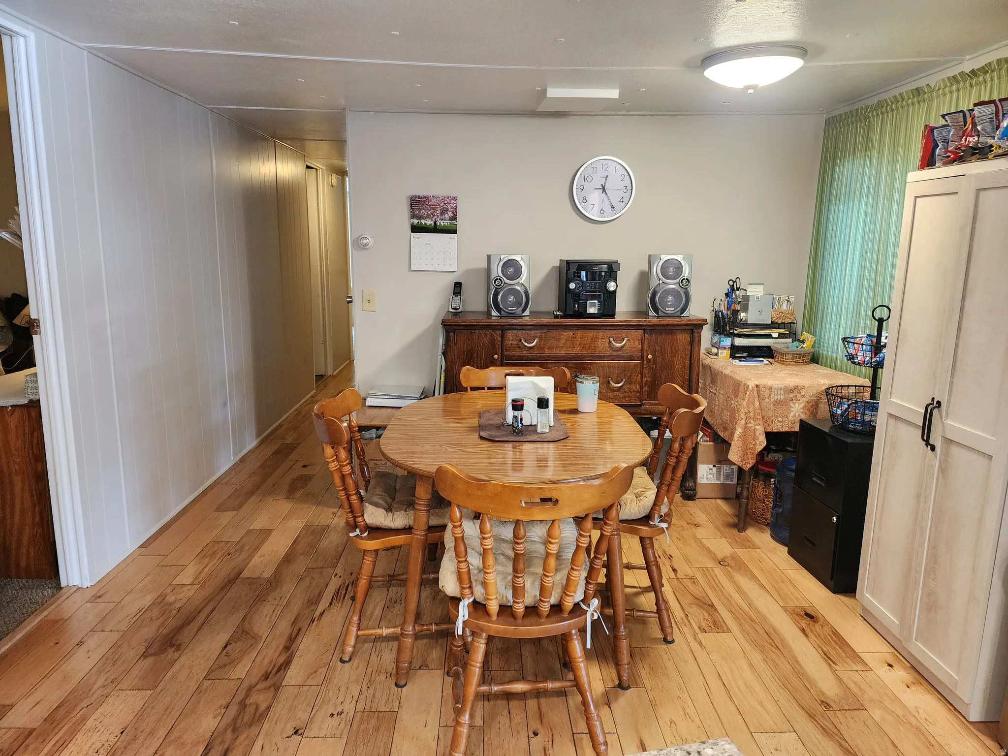 Dining area featuring wood-finish flooring, neutral wall paint, and a flush-mount ceiling light