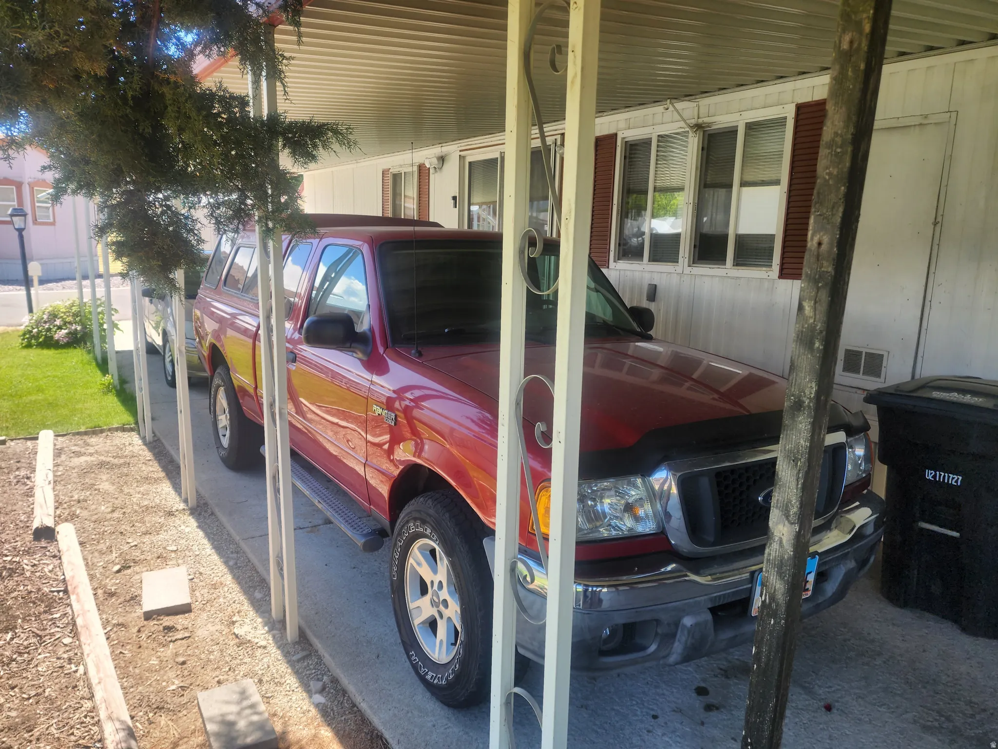 Carport parking with a concrete slab and metal supports