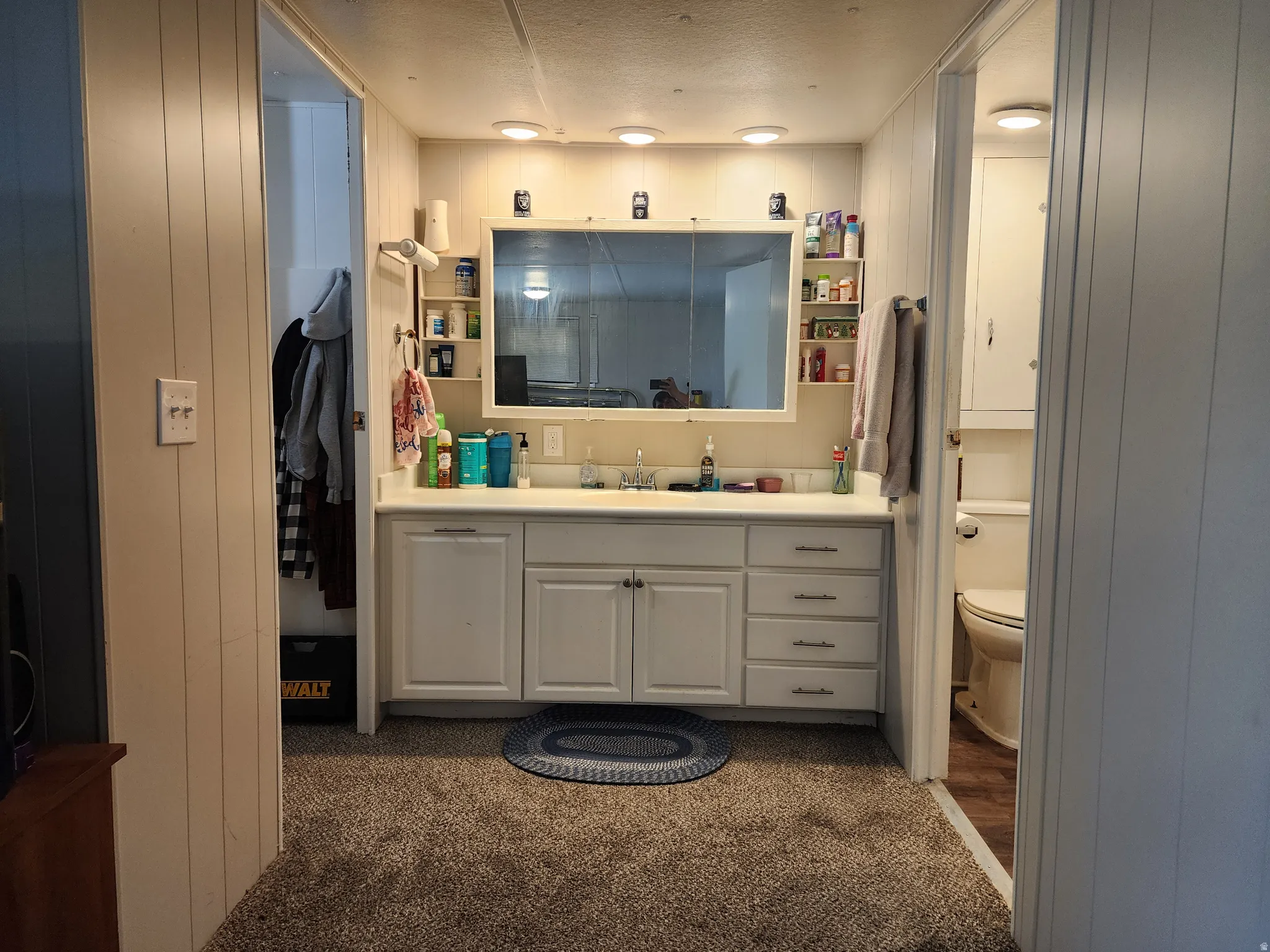 Vanity area featuring a dual-basin sink with a white countertop and recessed lighting