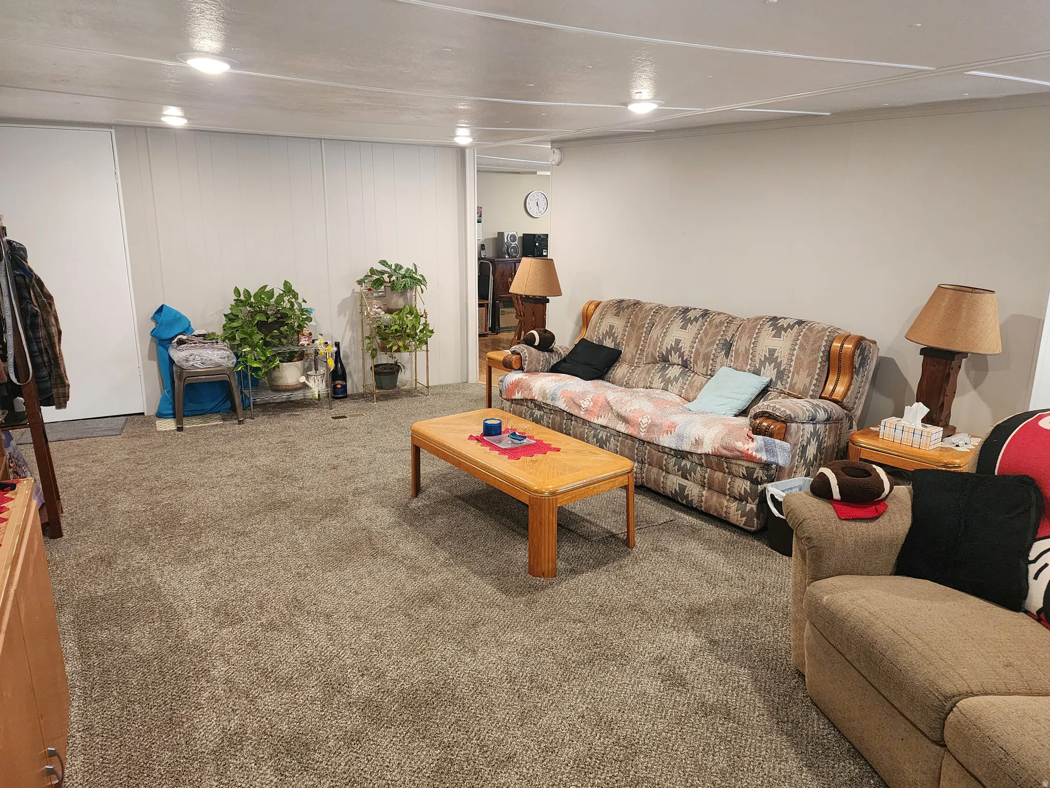 Carpeted room with recessed lighting and a neutral color palette
